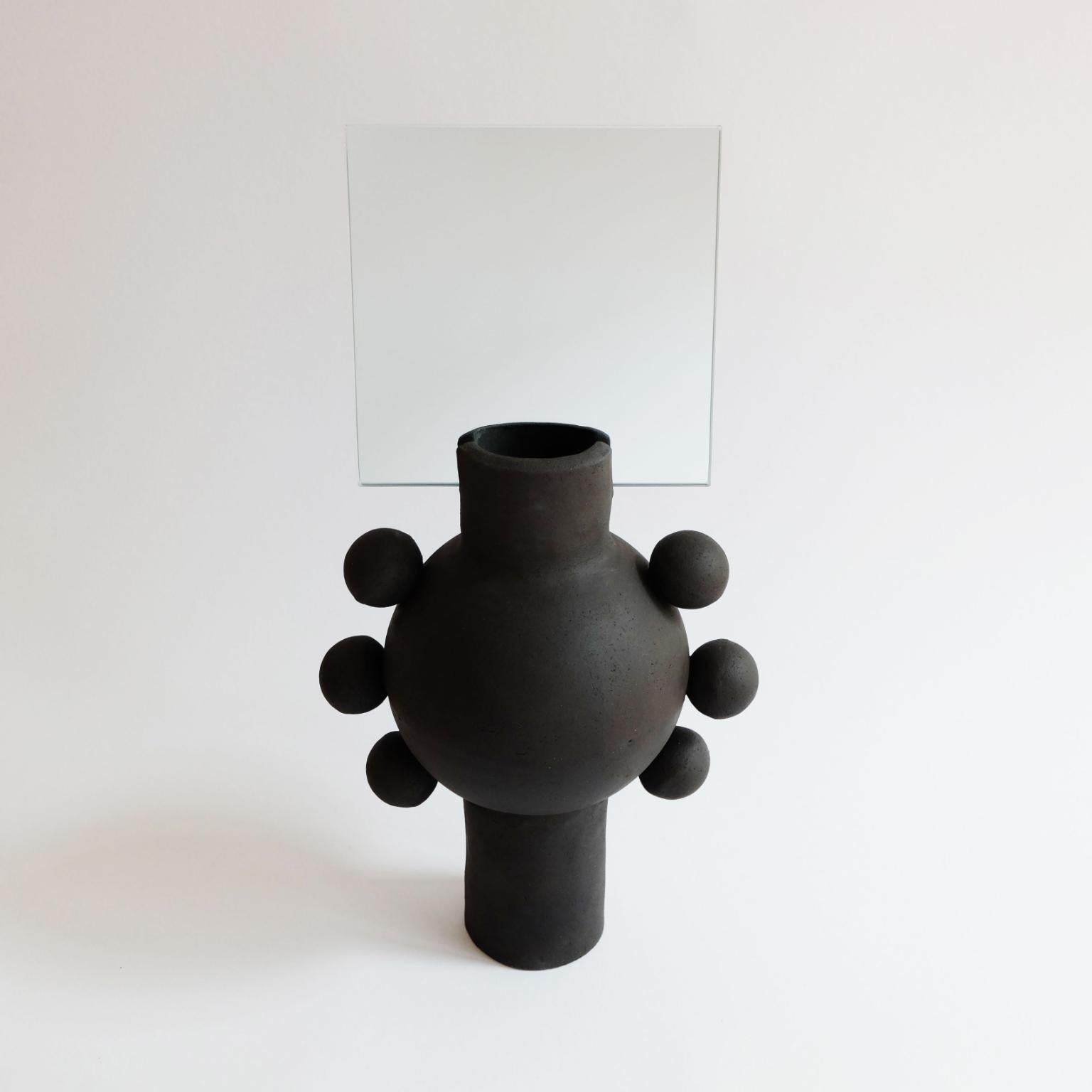 Unique UFO mirror by Ia Kutateladze
Dimensions: W 19 x H 38 cm
Materials: Raw black clay

UFO 01 is a hand built ceramic mirror. Playful and bold functional decorative object, for various types of interiors.

IAAI / Ia Kutateladze is a