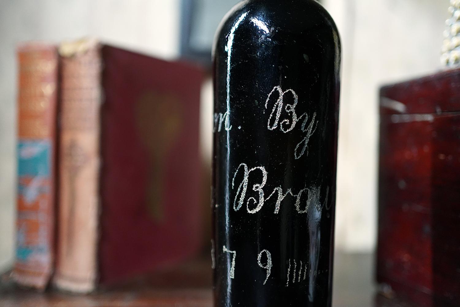 The charming and unique blue glass wine bottle of typical form, with a flanged lip and hand engraved lettering reading ‘Blown by Joseph Brown 1879’, and the letter ‘P’ to the base, surviving from the last quarter of nineteenth century