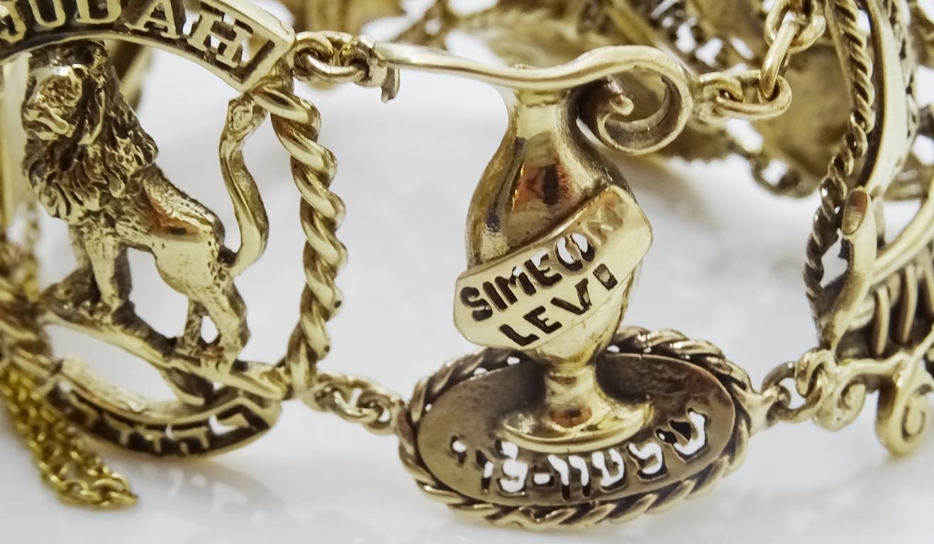 This unique vintage bracelet boasts  panels depicting  Ten of the Tribes of Israel.
Dan is symbolized by a snake\
Judah by a Lion
Shimon and Levy by a Jug
Zebulon by a sailing boat 
Asher by a bunch of grapes 
Gad also by a boat
Menashe by a flower