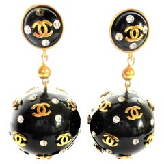 Unique Retro Chanel black big ball clip on earrings, plastic 1970s with gold