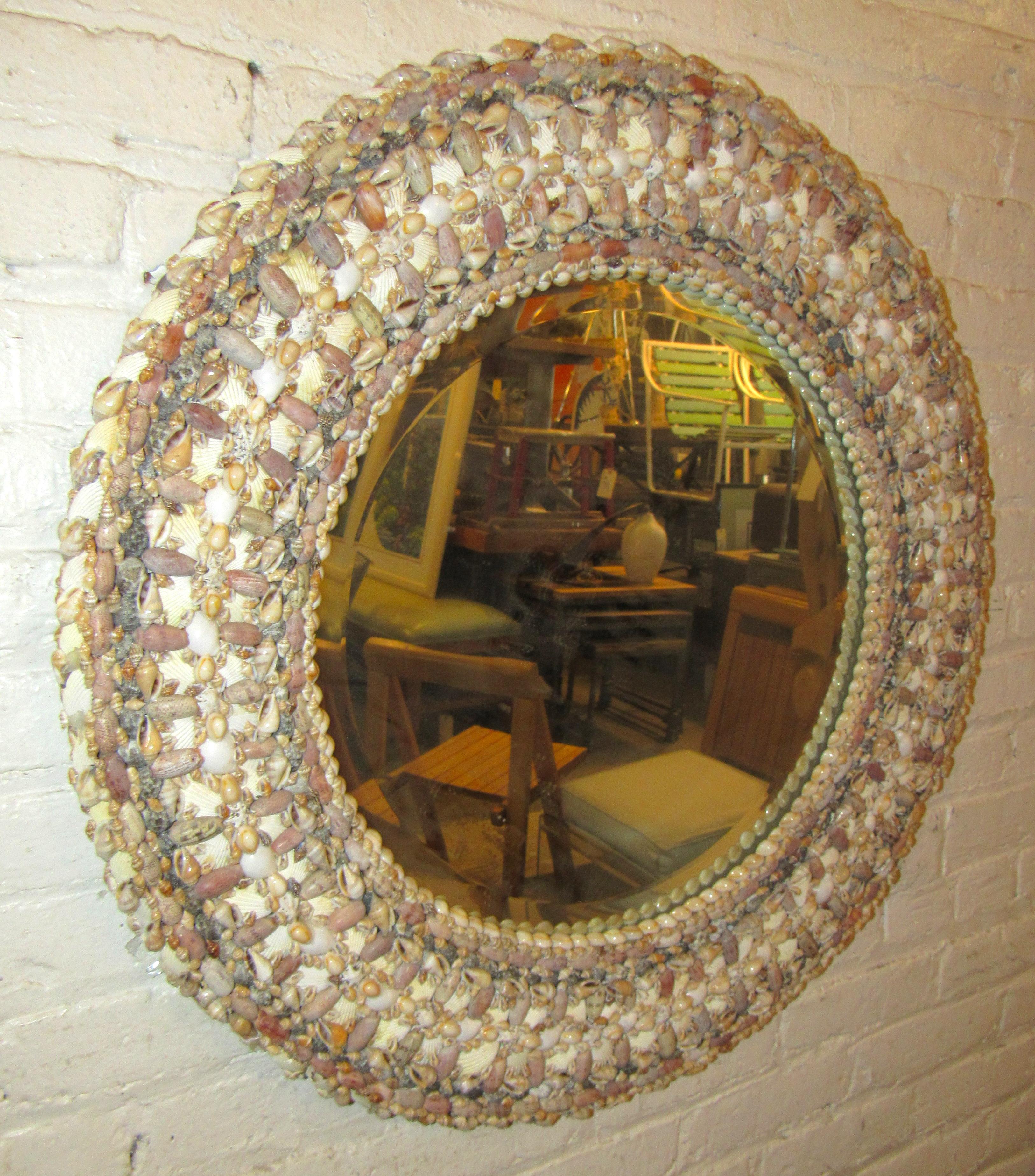 Miroir circulaire biseauté de style vintage unique, entouré d'un cadre en coquillages. Il s'agit d'un excellent complément à votre maison de vacances.