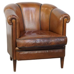 Unique vintage cognac-coloured leather club armchair with black piping