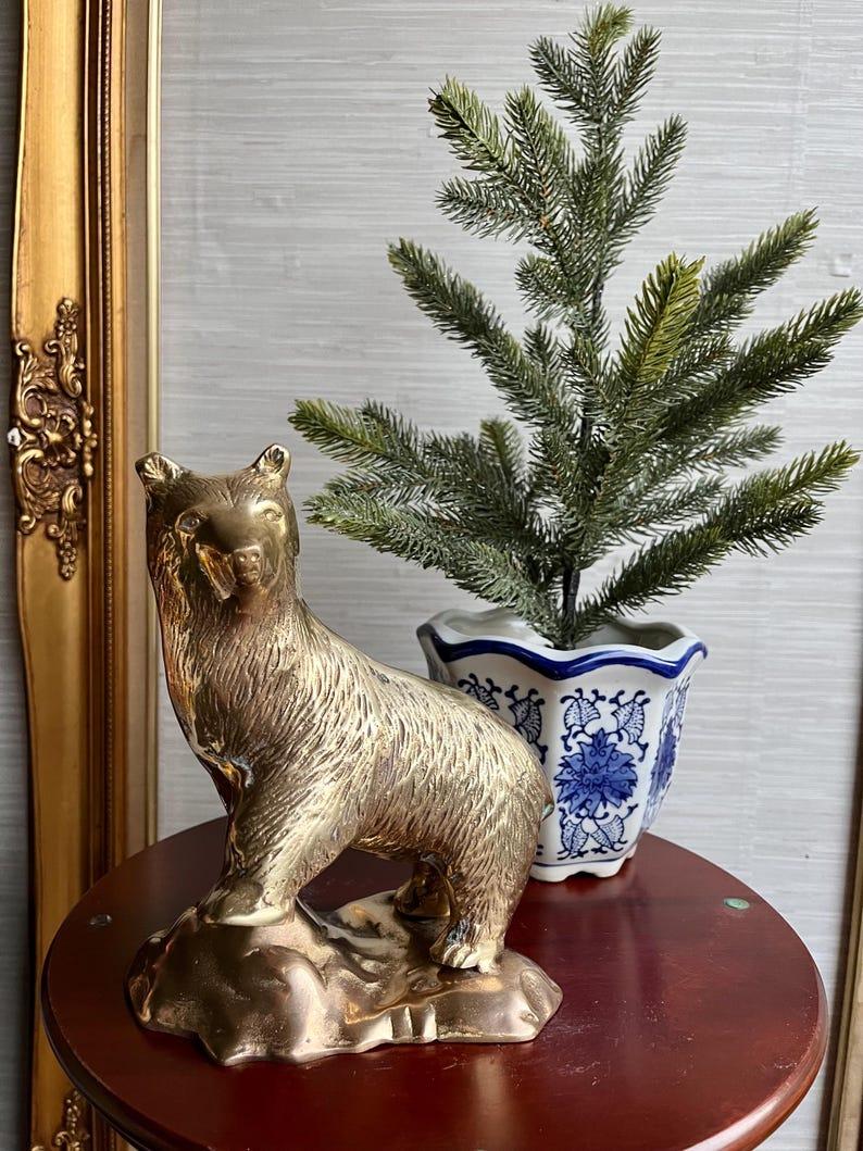 Il s'agit d'une statue d'ours en laiton absolument magnifique, représentant un ours confiant se tenant fièrement sur une colline rocheuse. Avec ses détails gravés complexes, cette pièce capture la force et l'élégance de l'ours, ce qui en fait un