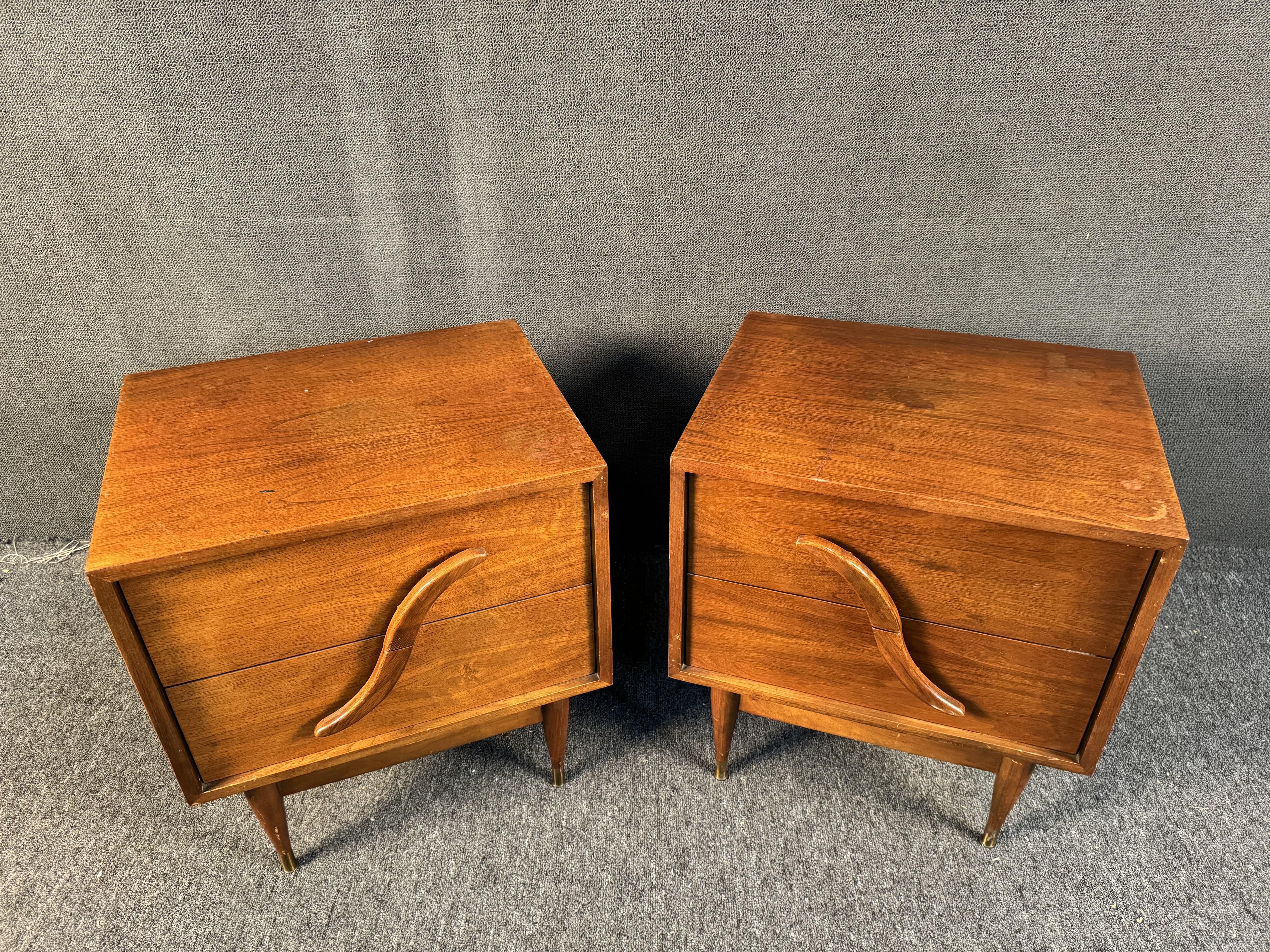 Mid-Century Modern Pair of Nightstands by Unagusta. Featuring unique sculpted handles and 4 drawers. Please confirm location with dealer (NY or NJ)
