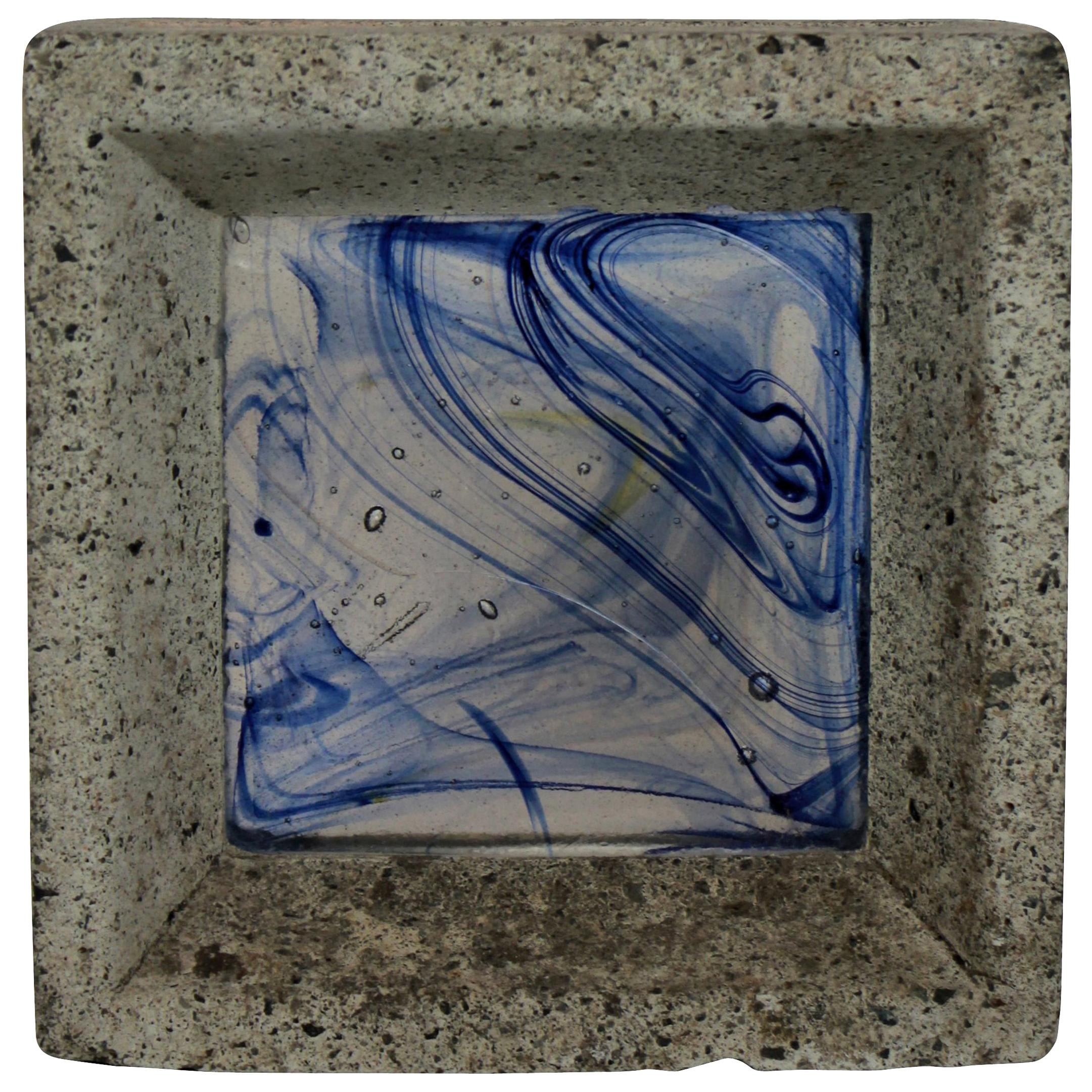 A Whitefriars Glass brick in concrete. Hand colored.
  