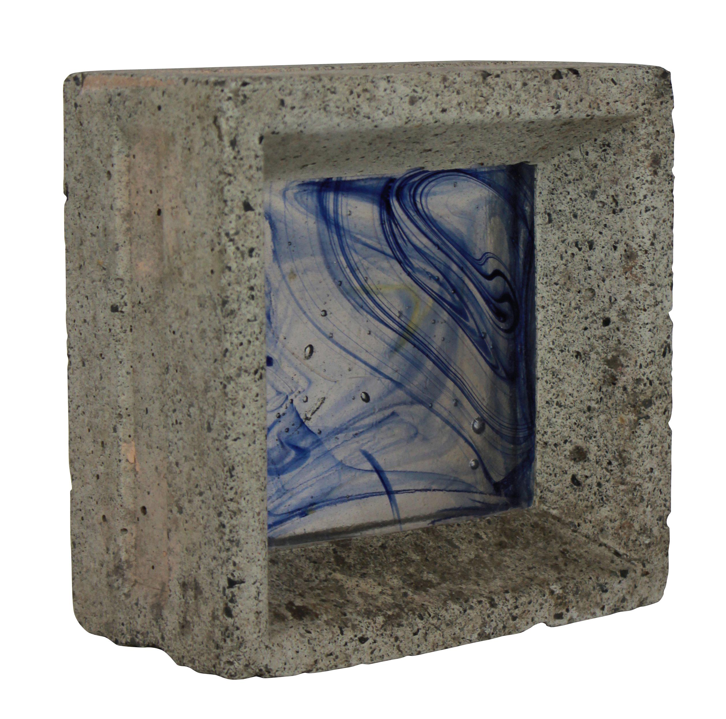 A Whitefriars glass brick in concrete. Hand colored.
 