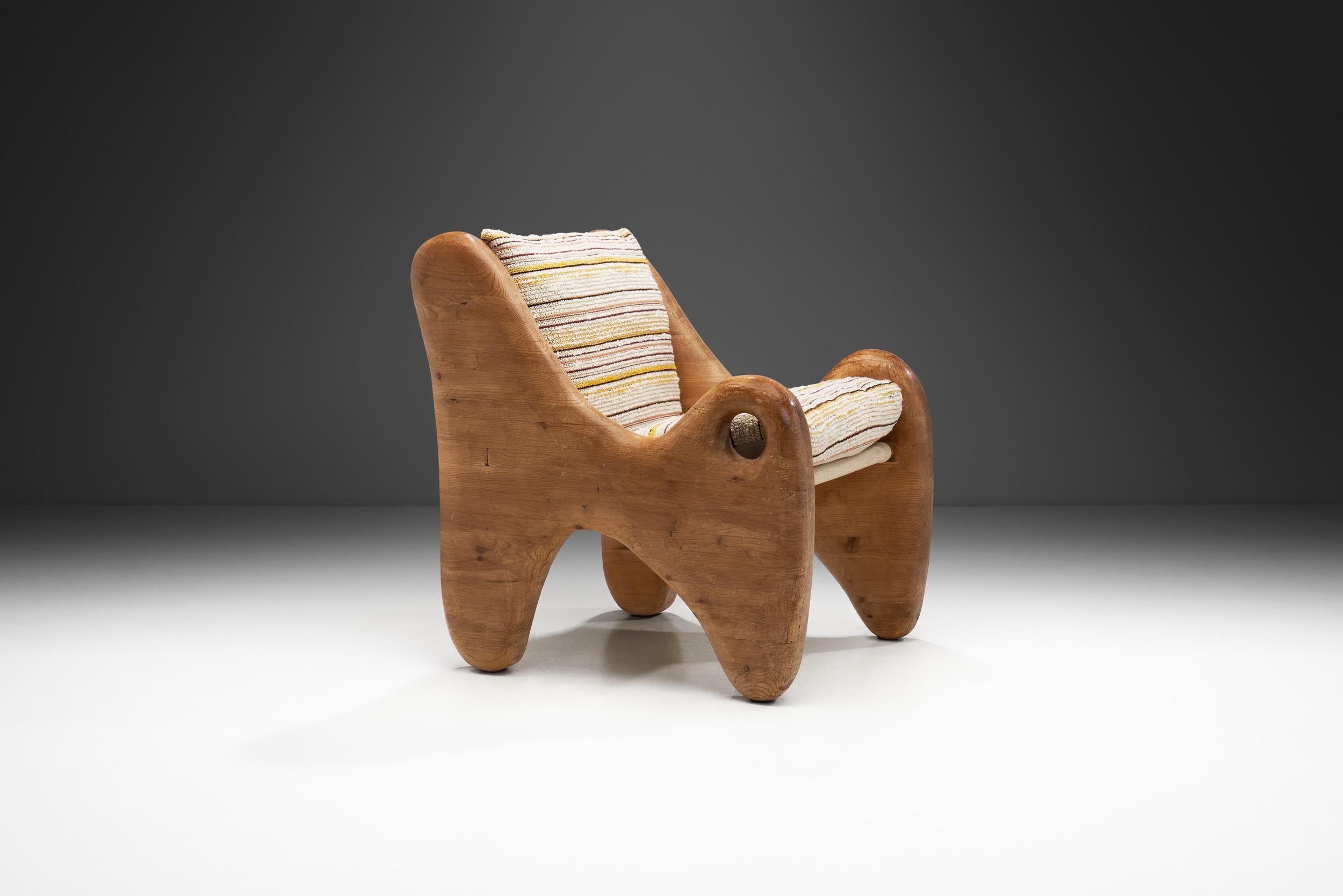 The 1960s were a decade of artistic experimentation in design, and this uniquely shaped eccentric wooden French chair stands as a testament to that creative spirit. This chair is a true fusion of form and function, blurring the line between