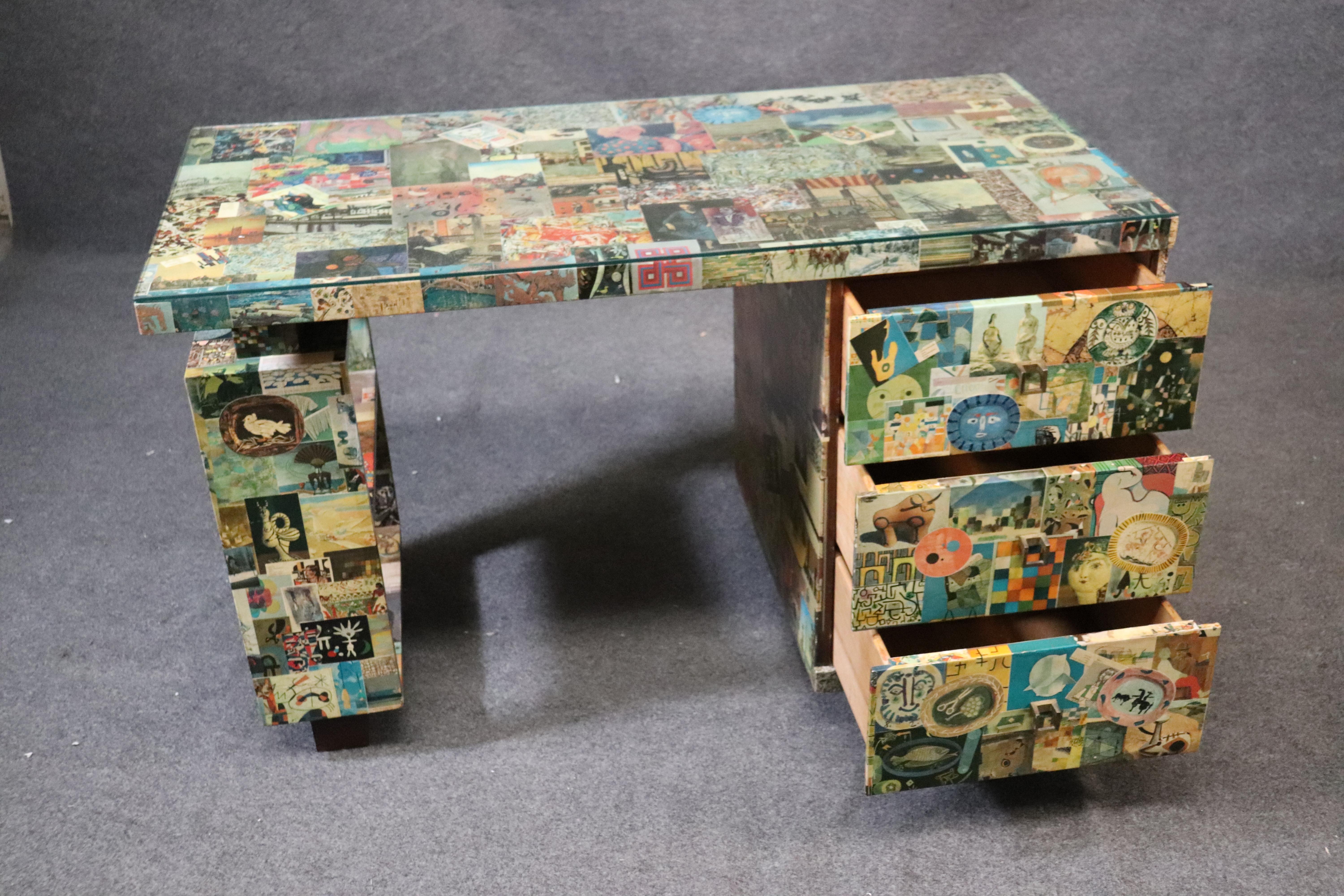 This is a unique desk, done in an unusual collage that gives it an artsy and uniquely modern look. The desk dates to the 1960s era and measures: 49 wide x 24 deep x 30 tall.