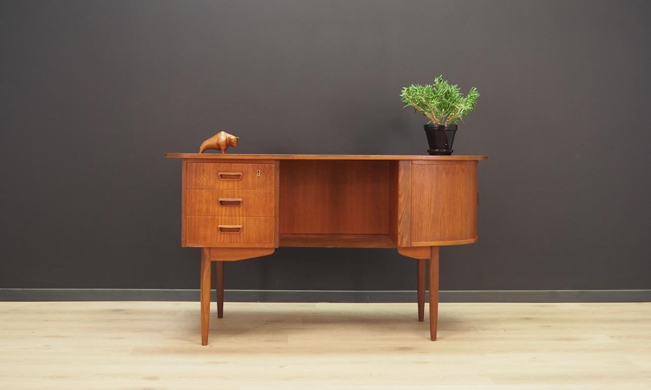 Stylish desk from the 1960s-1970s, Danish design. Classic Danish minimalism. Finished with teak wood veneer. Fantastic front with seven drawers. Bookshelves at the back. The key in the set. Preserved in good condition (small bruises and scratches) -