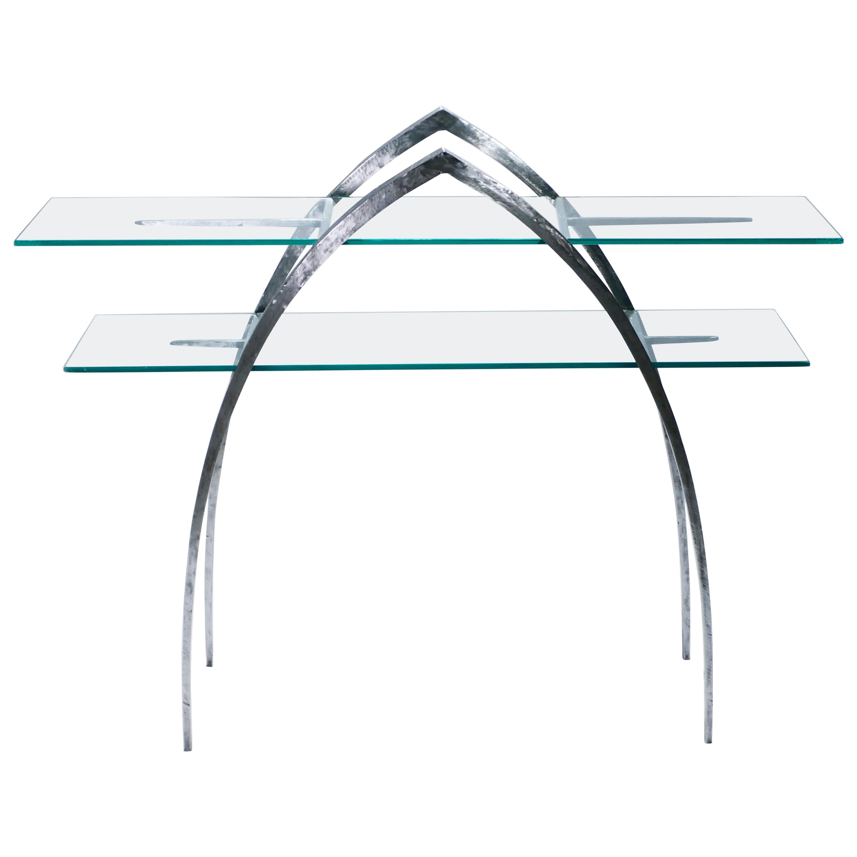 Beautiful French brutalism wrought iron and glass console table made in the early 2000s. The iron structure is sharp and imposing from a distance, two pointed arches and spears serving as the only elements. Sheets of transparent glass, forming two