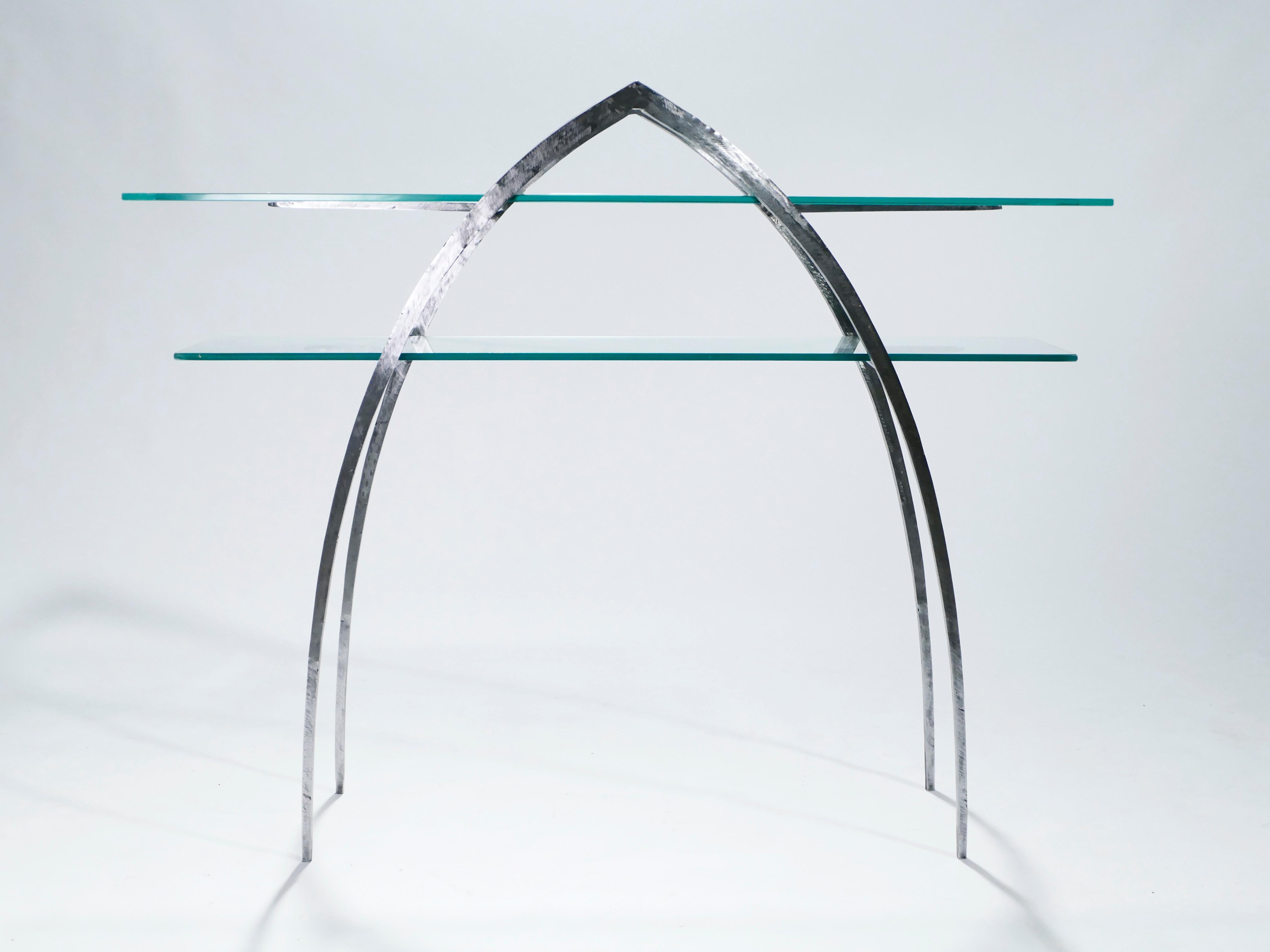 Beautiful French brutalism wrought iron and glass console table made in the early 2000s. The iron structure is sharp and imposing from a distance, two pointed arches and spears serving as the only elements. Sheets of transparent glass, forming two