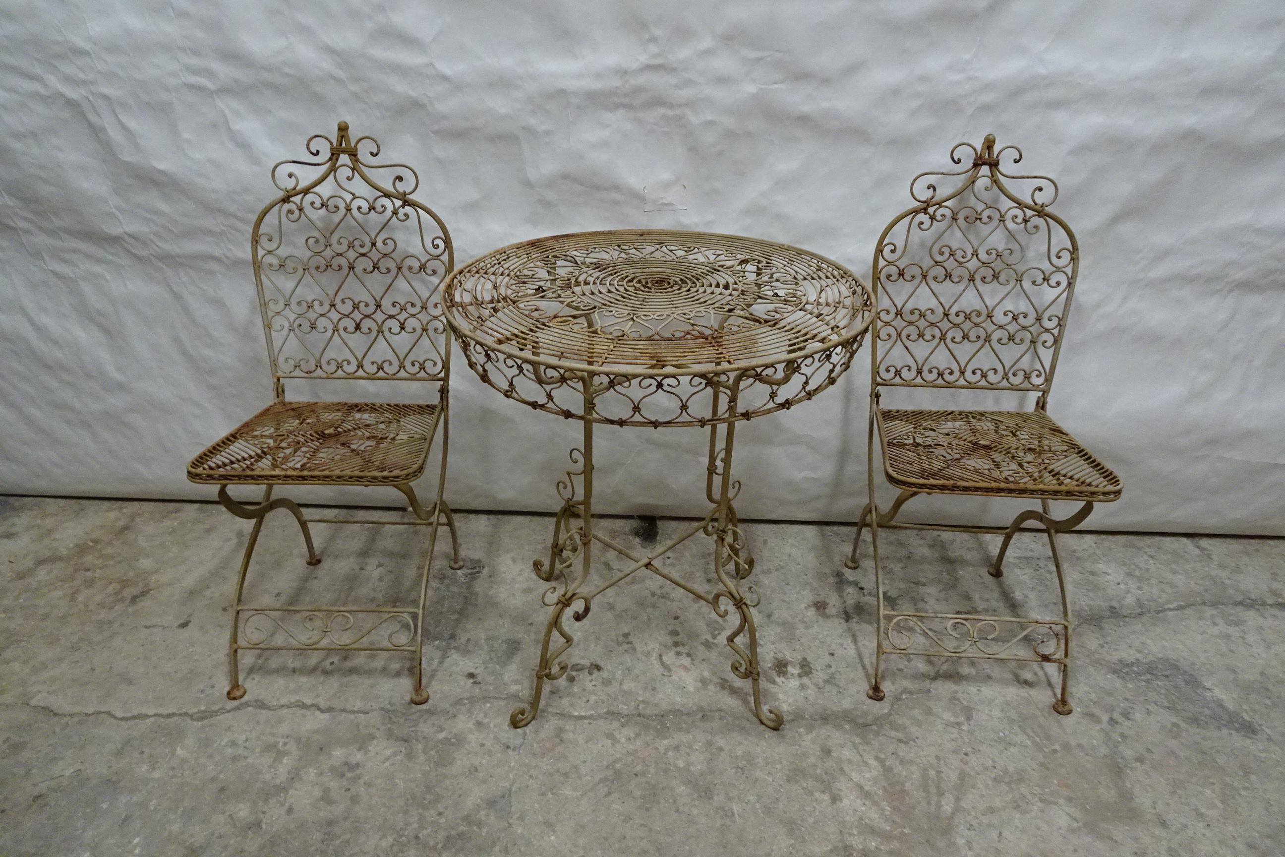 This is a Unique Wrought Iron Table + Chairs in original condition.