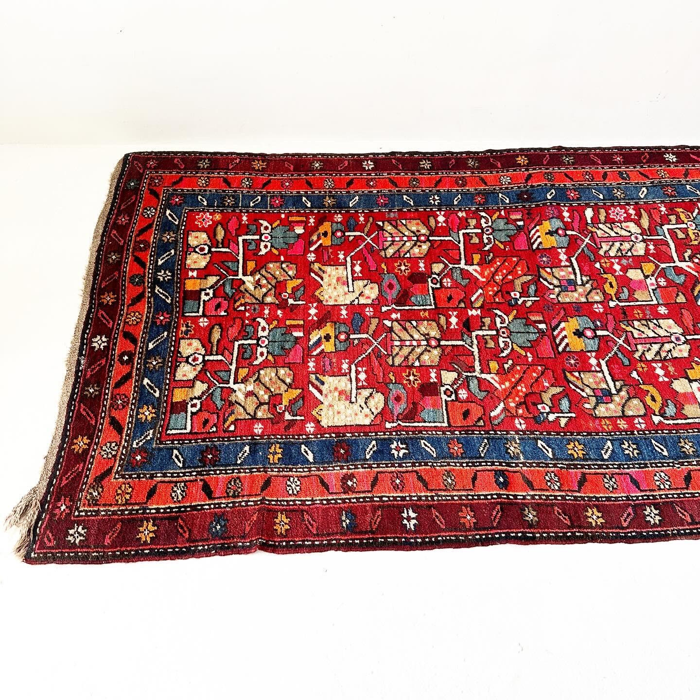 Uniquely shaped vintage hand knotted Turkish rug with low pile -- long like a runner, but as broad as a standard rug. Vivid colors, one of my favorites!

L139 (11' 7