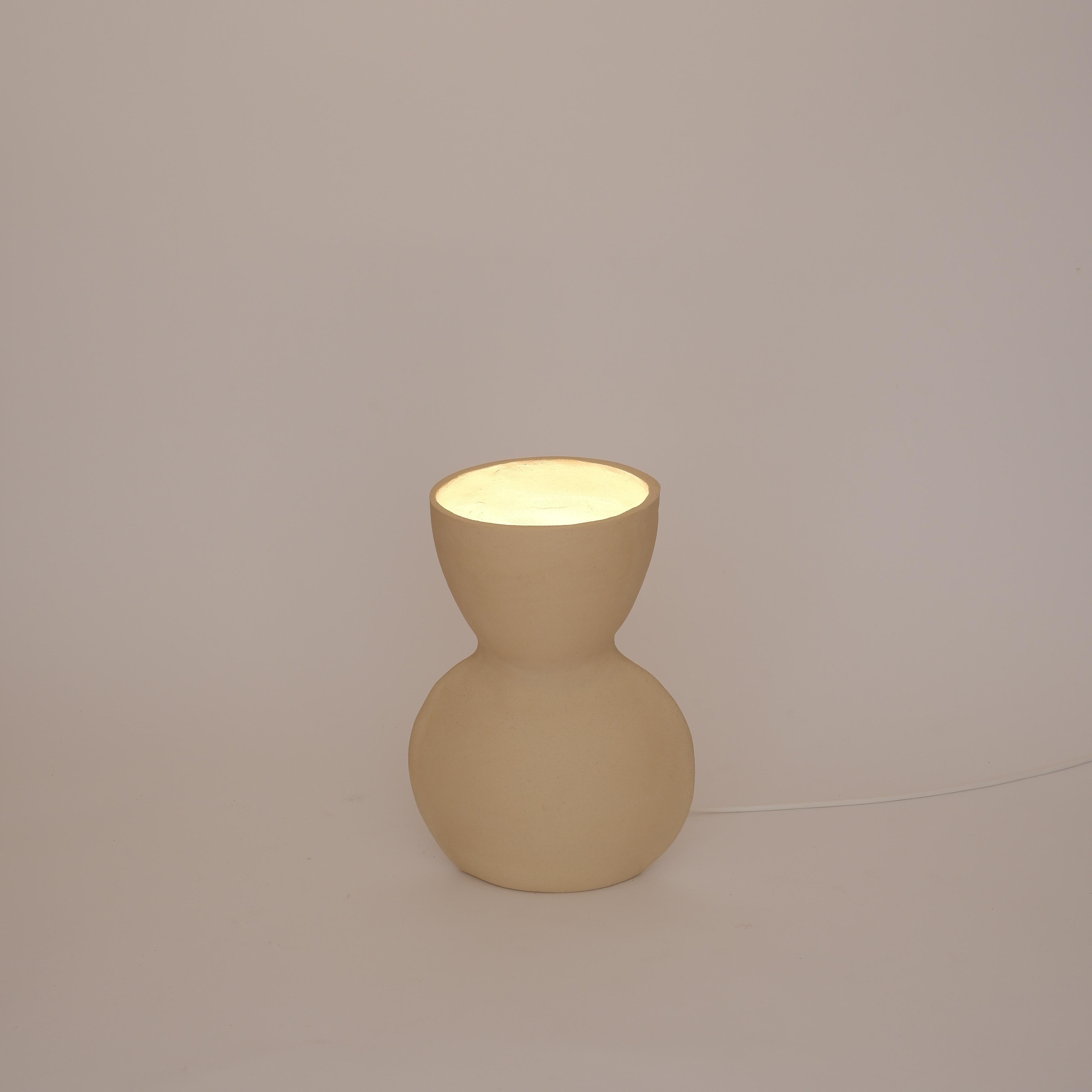 Unira Small White Lamp by Ia Kutateladze
One Of A Kind.
Dimensions: D 14 x W 18 x H 25 cm.
Materials: Clay.

Each piece is one of a kind, due to its free hand-building process. Different color variations available: raw black clay, raw white clay and