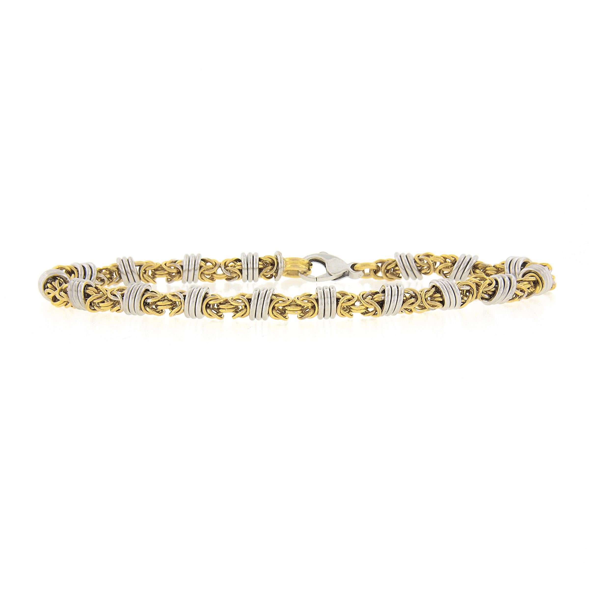 This unique and very well made byzantine link chain bracelet is crafted in solid 14k yellow gold with white gold circle links evenly spaced throughout. The bracelet measures 5.8mm wide and has a wonderful high polished finishing throughout, securing