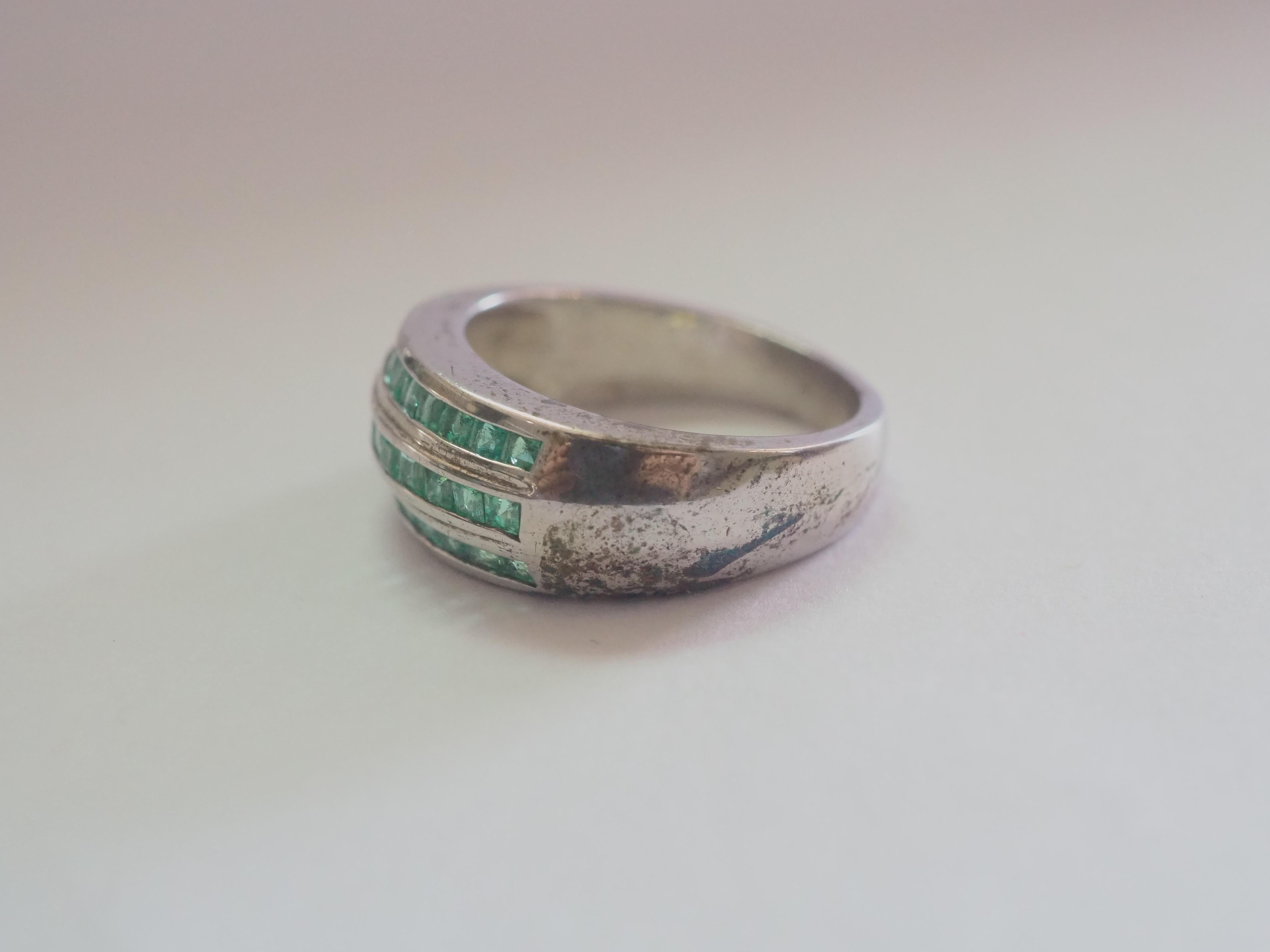 This ring is a stunning unisex band ring in solid sterling silver. The ring is decorated by natural and decent squared emeralds inlaid beautifully into 3 rows. The emerald gemstone is one of the most popular in the gem world with rich history and