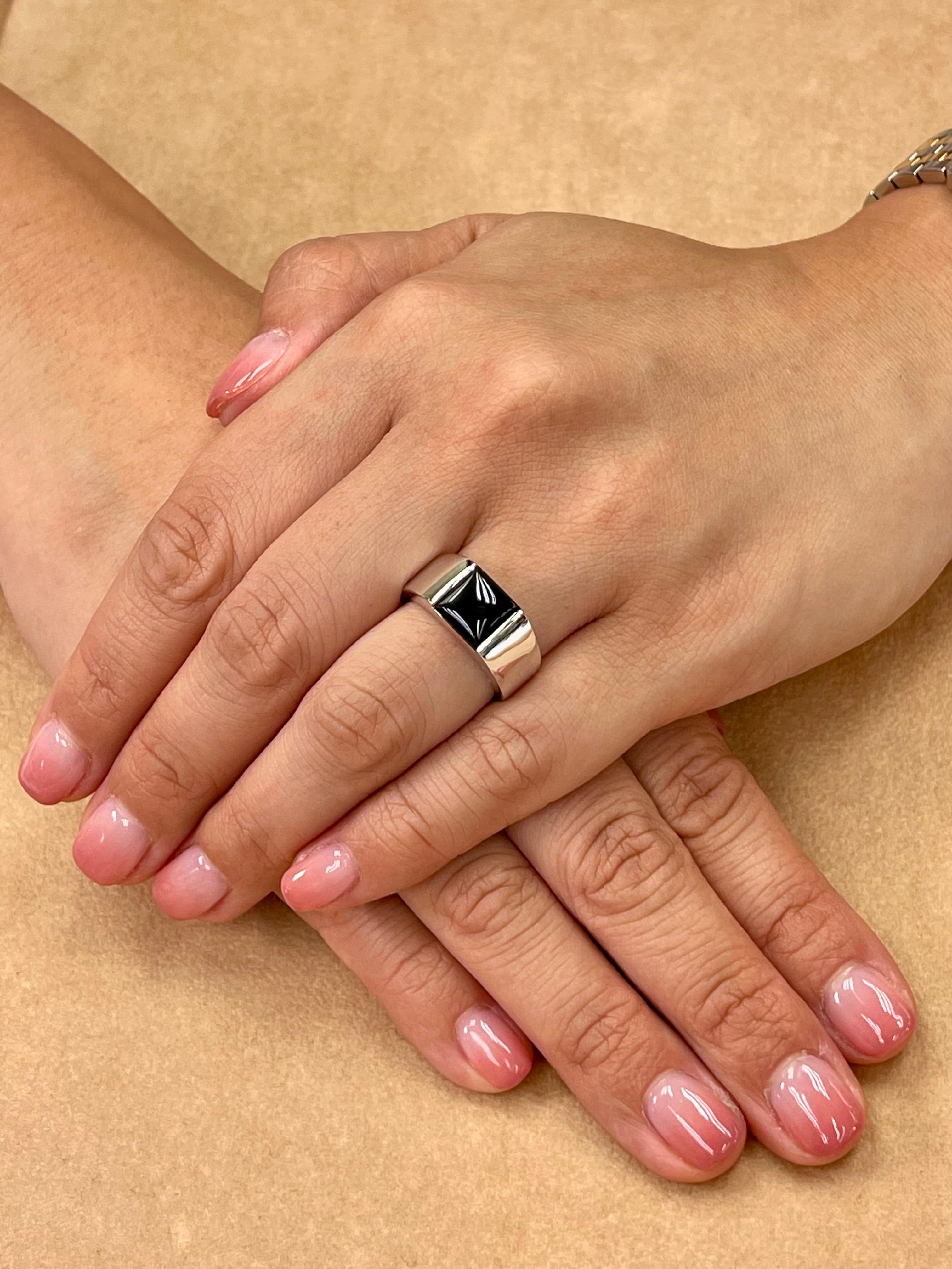 Please check out the HD video. New Old Stock. This is a unisex ring. The center is a onyx. The center onyx is about 9 x 7mm. The ring is set in solid 18k white gold. It's solid at around 10.14 grams. The onyx is black. This will be a great gift for