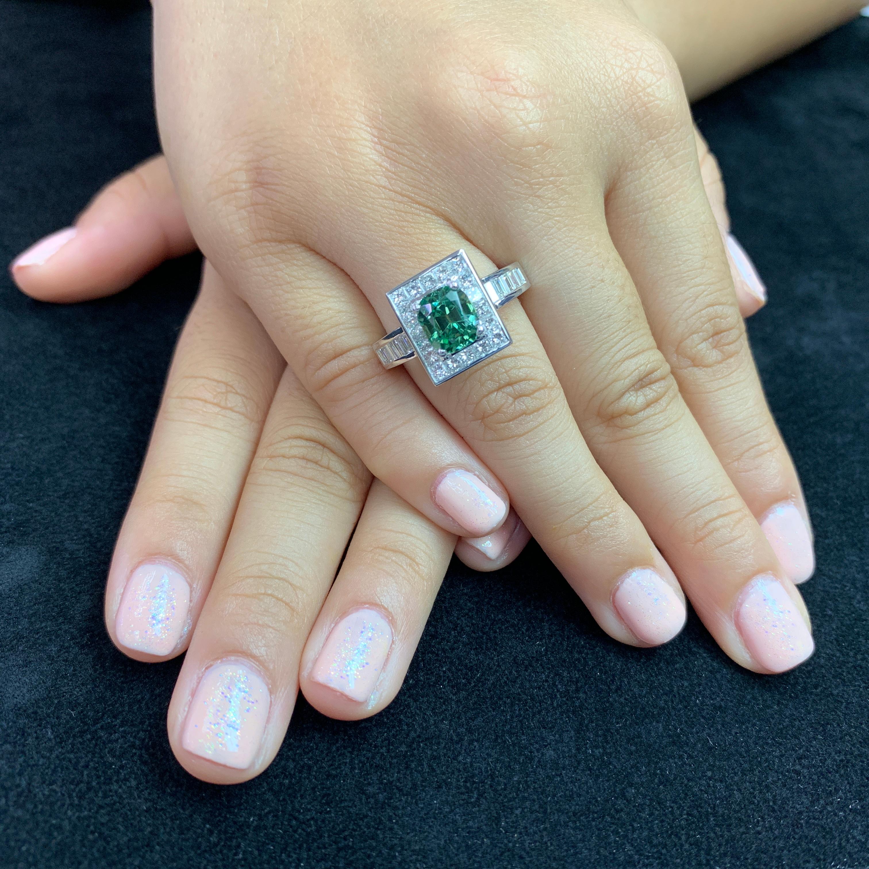 Here is a beautiful mint green tourmaline 2.02cts and diamond ring. The ring is set in 18k white gold and diamonds. There are 18 princess cut diamonds in this setting totaling 0.77 cts and 18 baguette cut diamonds totaling 0.51 cts. All in all 1.28