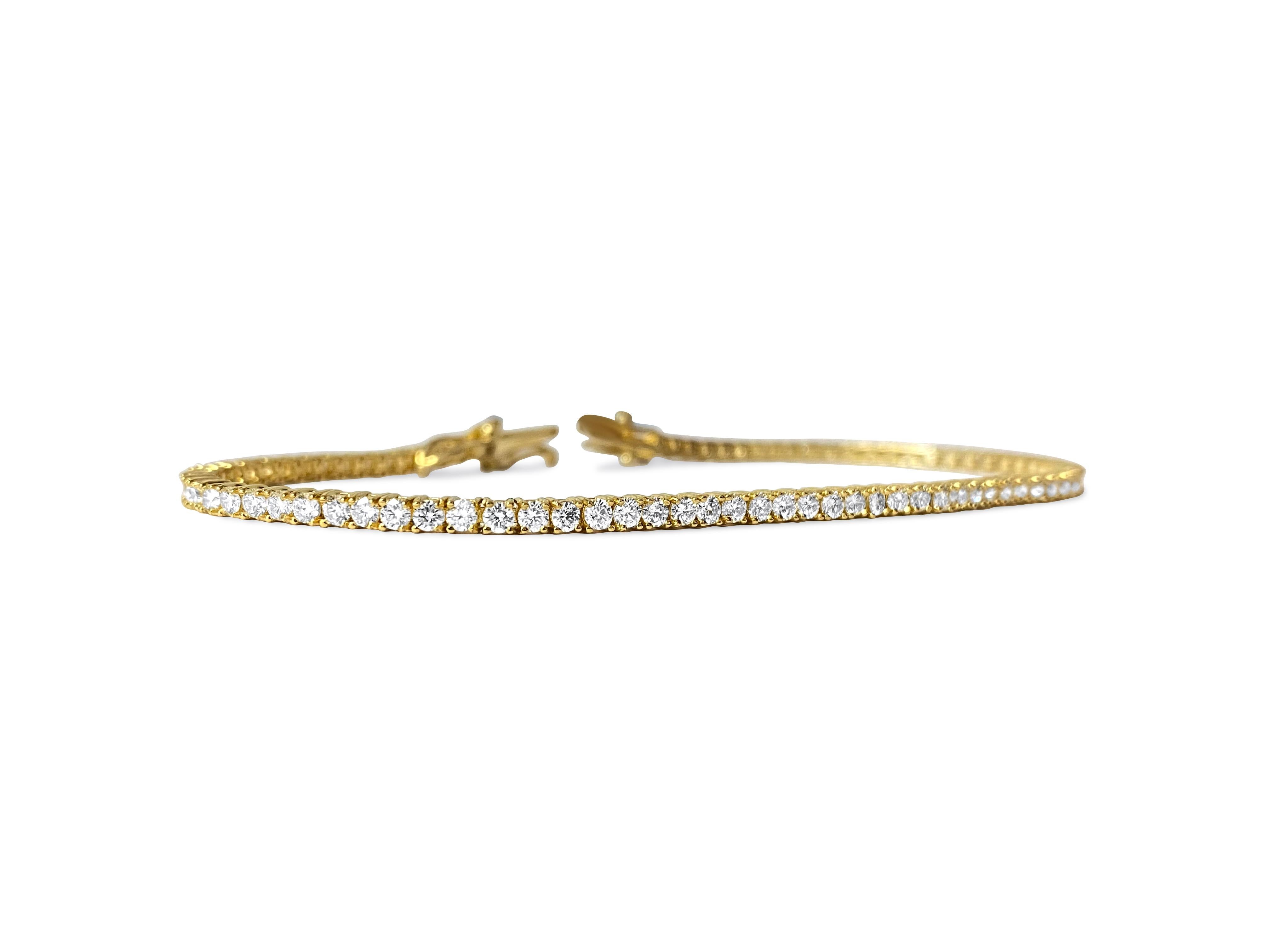 Material: The bracelet is made of 14-karat yellow gold. It has diamonds that weigh 3.08 carats in total. The diamonds are really clear (VVS-VS clarity) and have a color grade of H. They are all natural, mined from the earth. The diamonds are cut in