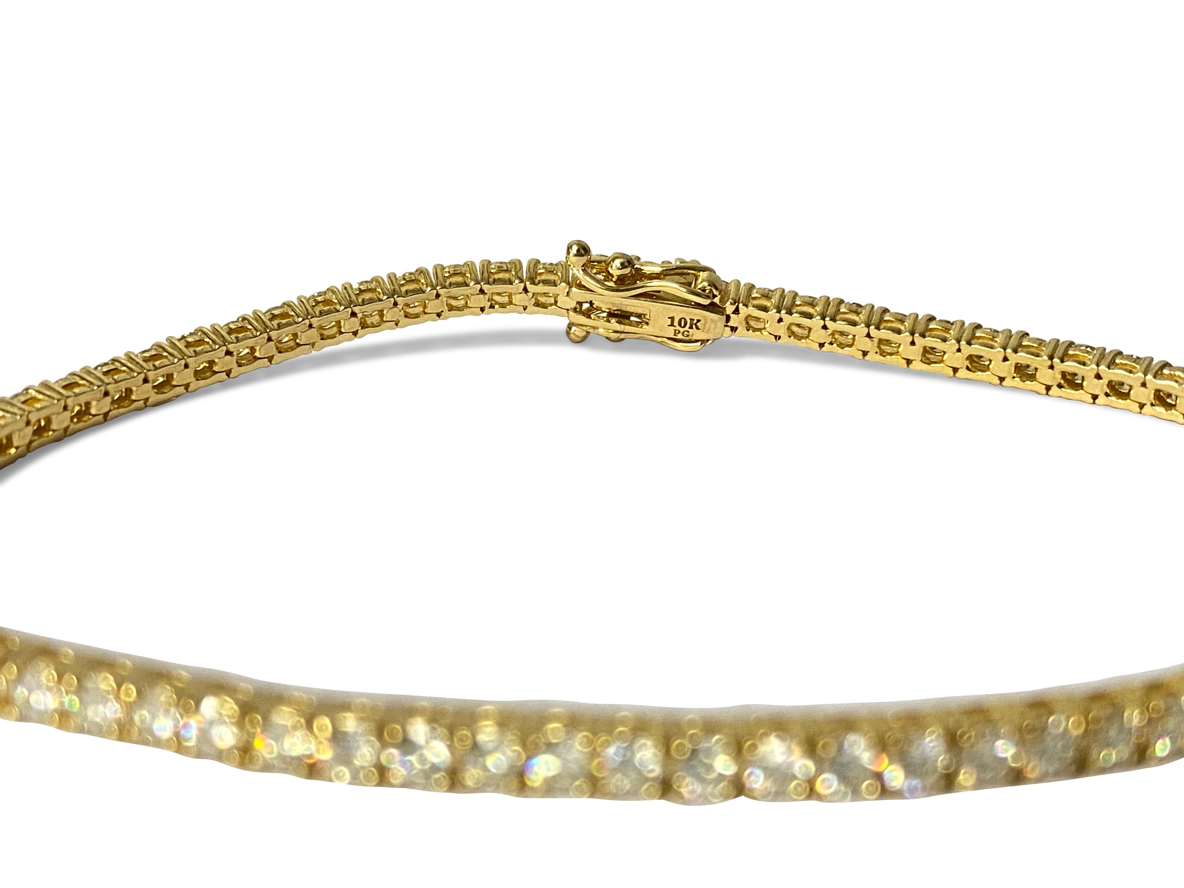 Crafted from luxurious 14k yellow gold, this exquisite unisex diamond tennis bracelet boasts a total carat weight of 5.00, featuring diamonds with VVS-VS clarity and H color. Set in prongs, each round brilliant cut diamond sparkles with unparalleled