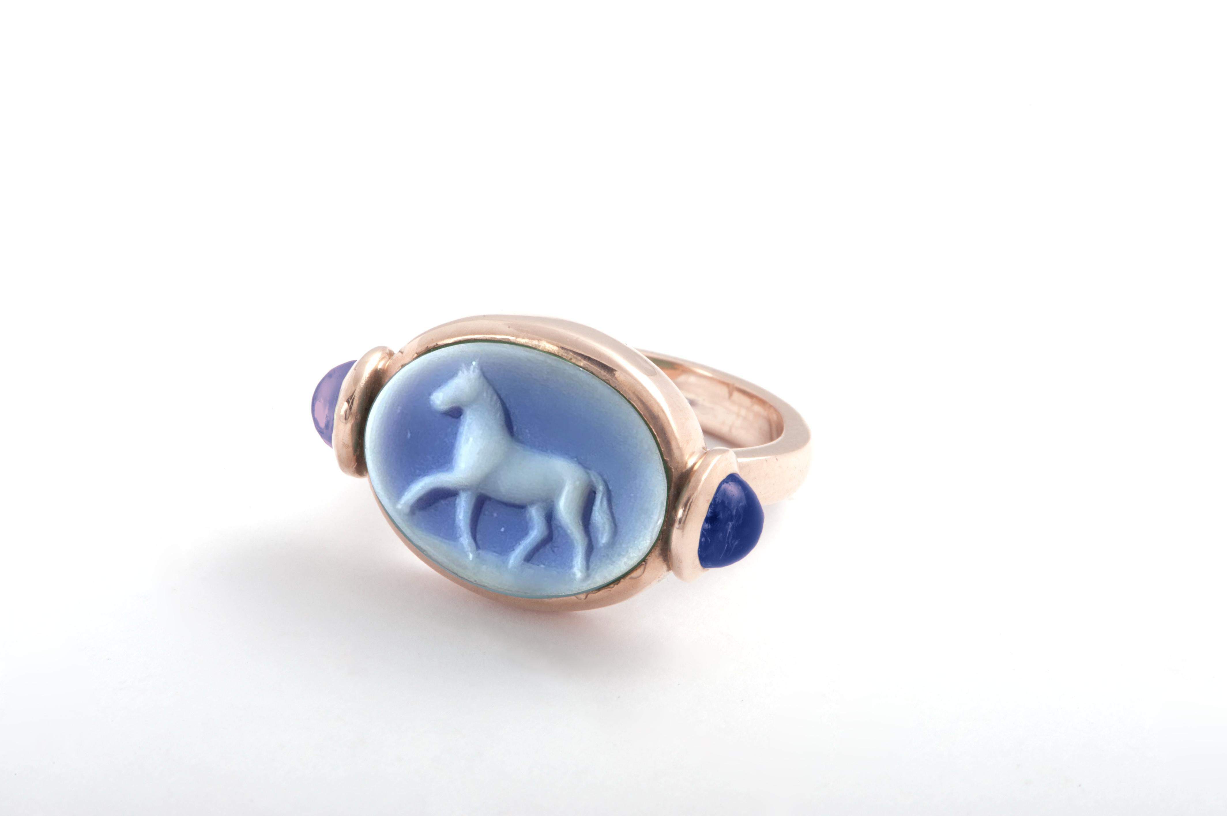Rossella Ugolini Design Collection a perfectly hand carved Blue Agate ring is Handcrafted in yellow gold embellish with two Indigo Blue cabochon cut Iolite.  A Unisex Unique Design Signet Ring  for a Horse Lovers. The horse is a solar animal. Due to