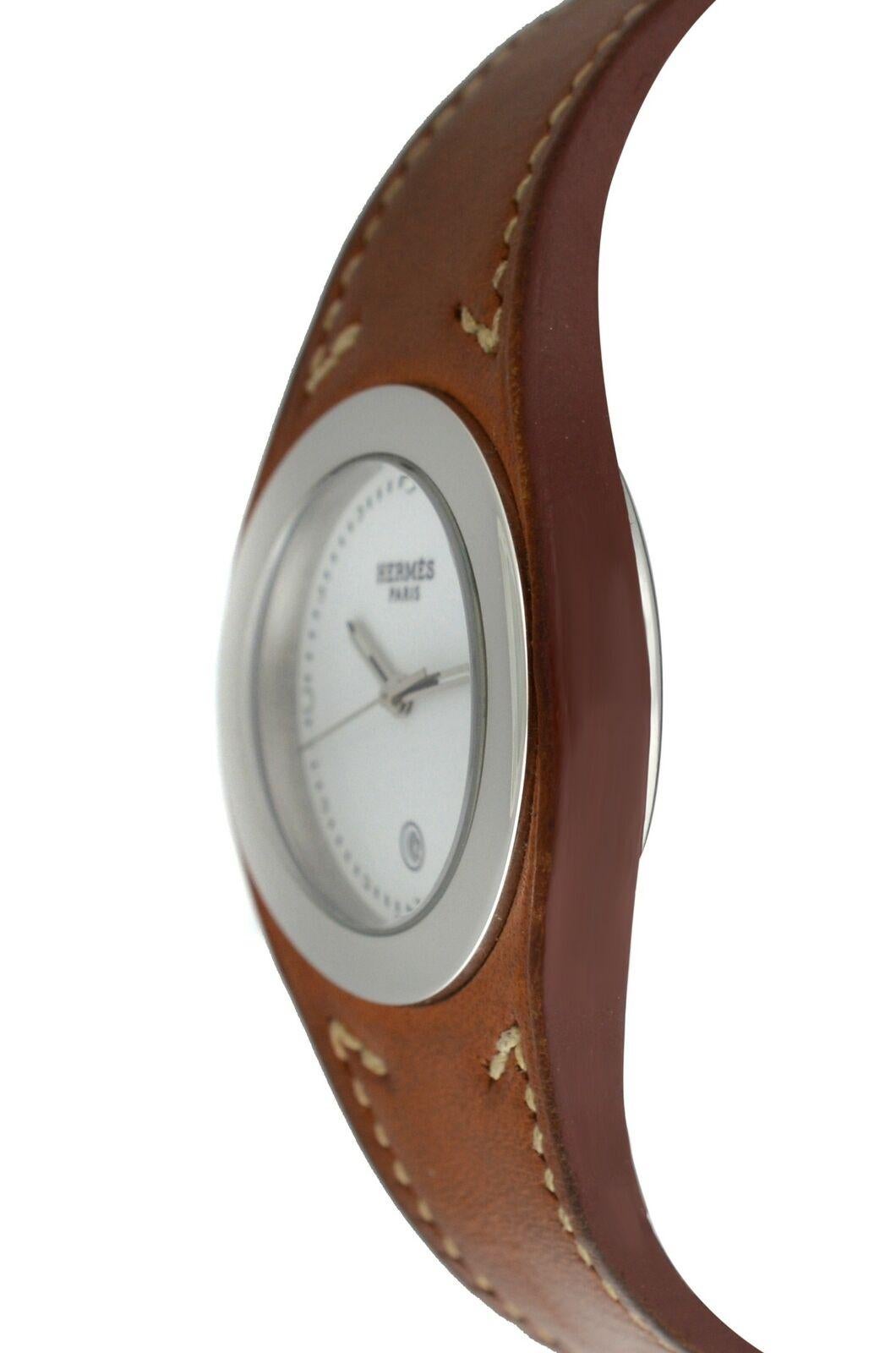 Brand	Hermes
Model	Harnais HA3.410
Gender	Unisex
Condition	Pre-owned
Movement	Swiss Quartz
Case Material	Stainless Steel
Bracelet / Strap Material	
Genuine Leather

Clasp / Buckle Material	
Stainless Steel	
Clasp Type	Deployment
Bracelet / Strap