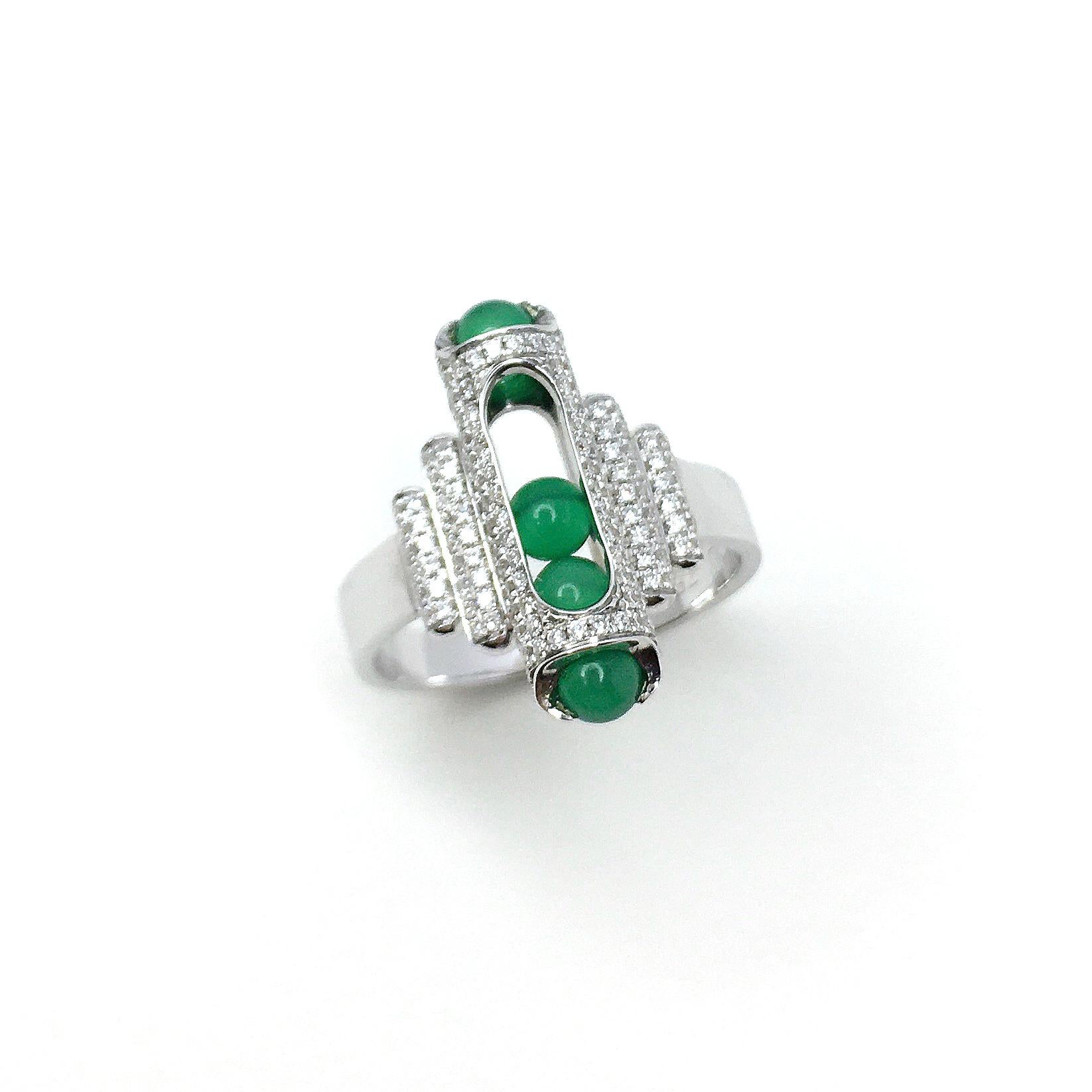 This unique Melody ring combines perfect hand carved green Chalcedony beads that roll within their 18 karat gold, pave diamond setting. Gold award winning Melody collection is a clever design solution. Each piece incorporates a unique movement