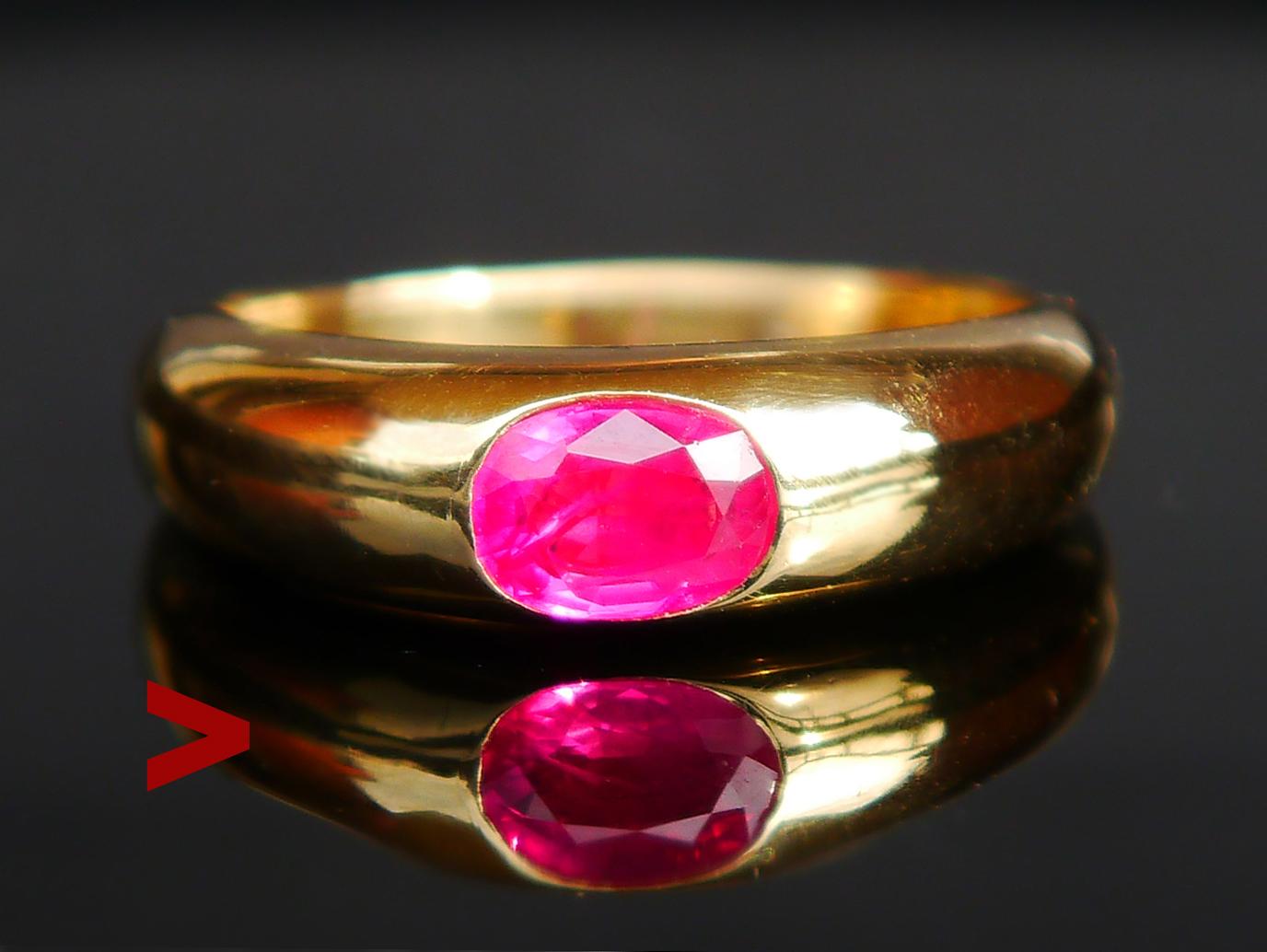 A  Ring in solid Yellow 18K Yellow Gold with oval cut natural Ruby stone, Red with tint of Pink color of medium intensity, oval cut  7 x 5 mm x 3 mm deep / ca. 1 ct. Inclusions and flaws visible under x 10 magnification.  Peculiar ventilation holes