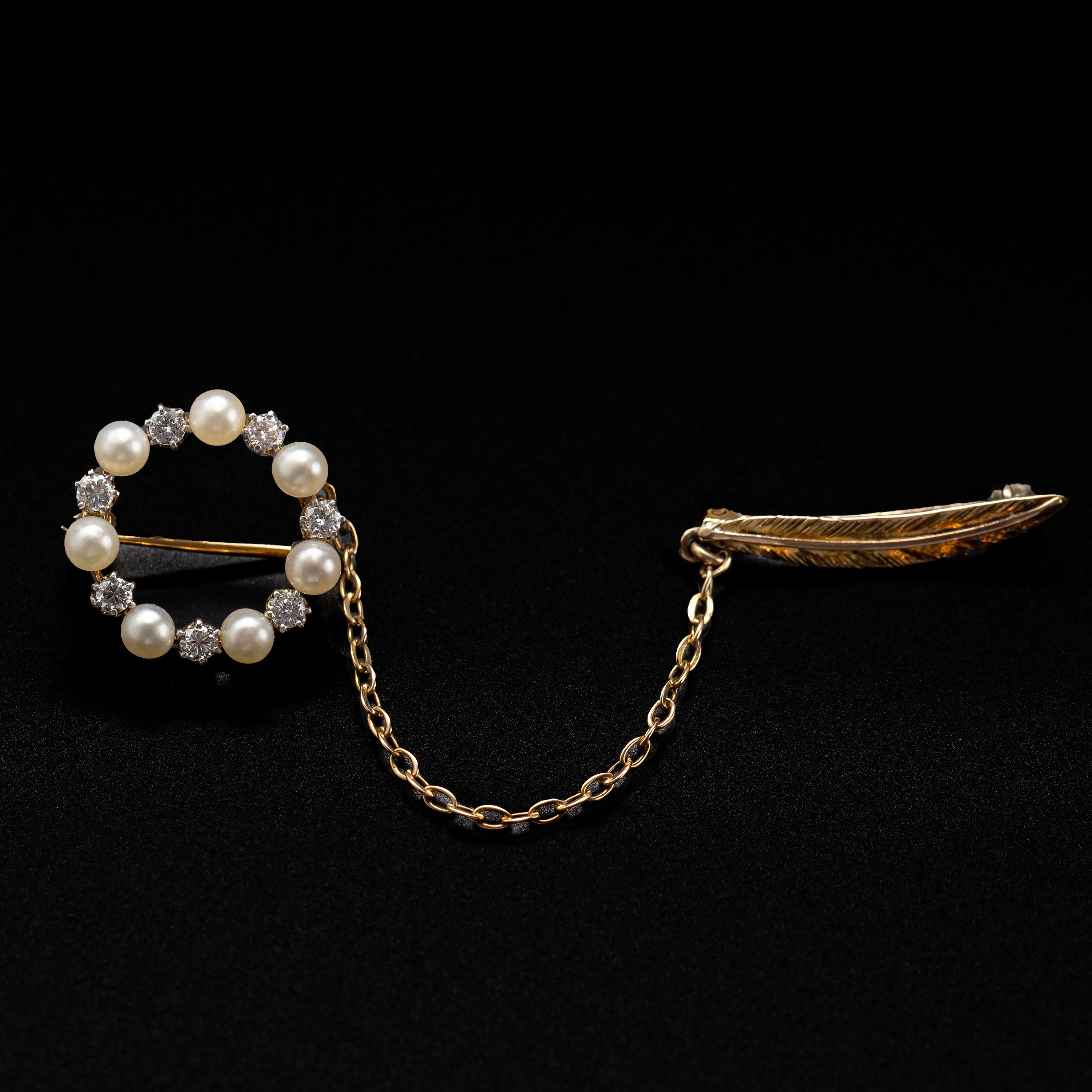 This simple and beautiful Victorian-era chatelaine brooch dates to about 1890 and features seven luminous GIA-certified natural saltwater pearls together with seven bright and sparkling diamonds that together way about .25 carats. A brief length of