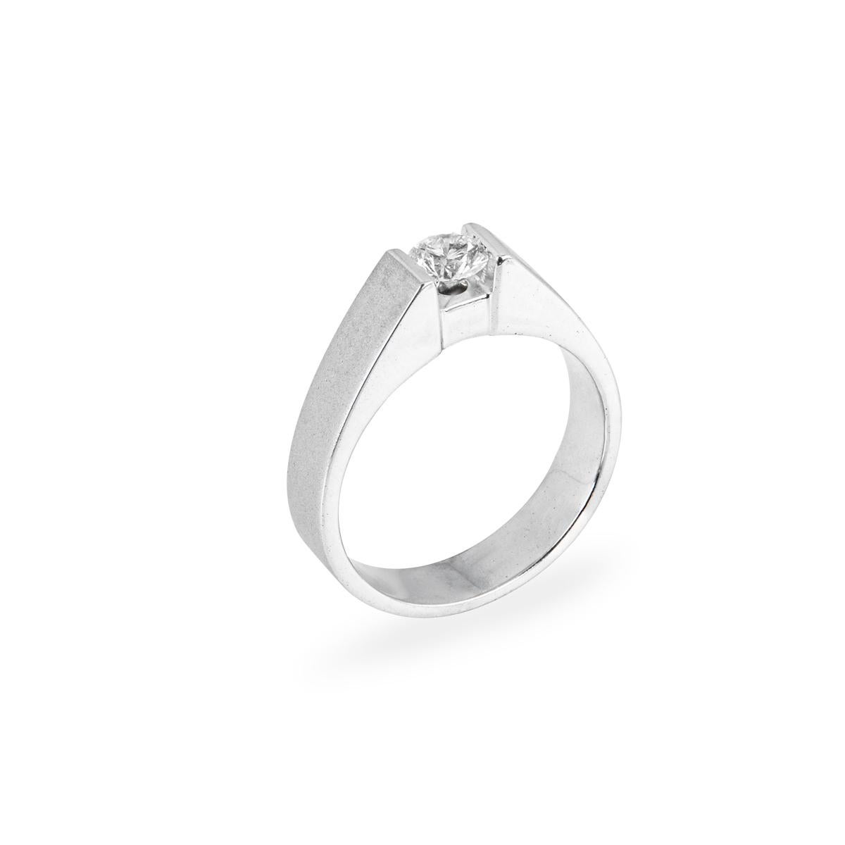 A contemporary 18k white gold round brilliant cut diamond ring. The 0.47ct round brilliant cut diamond is tension set within a sateen finish mount. The diamond is H colour and clarity is SI1 clarity. The ring is currently a size UK R / EU 59 but can