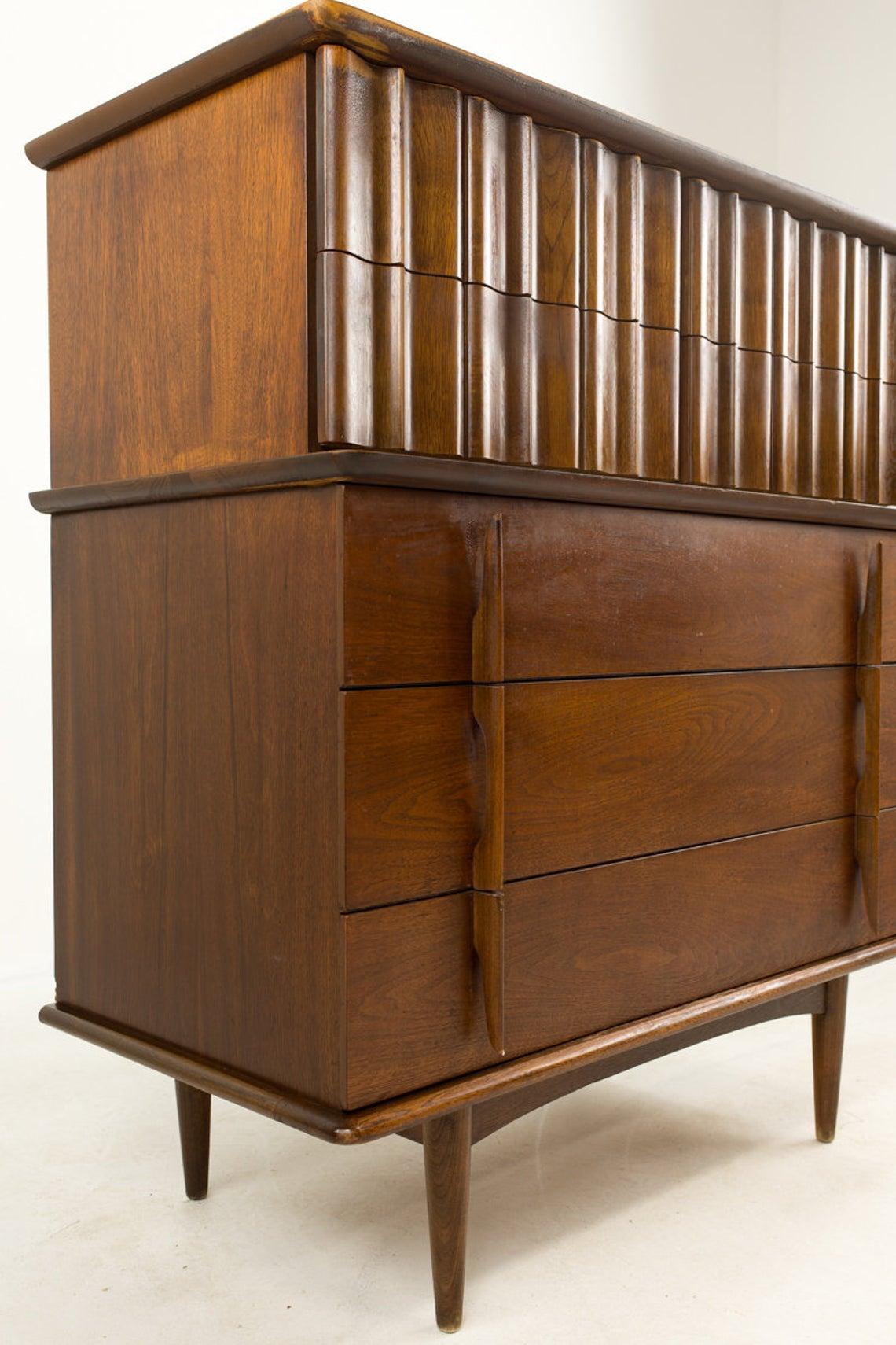 United Furniture Mid Century Walnut 5-drawer Highboy Dresser

Measures: Width 40 inches
Depth 20 inches
Height 45 inches

This price includes getting this piece in what we call restored vintage condition. That means the piece is permanently fixed