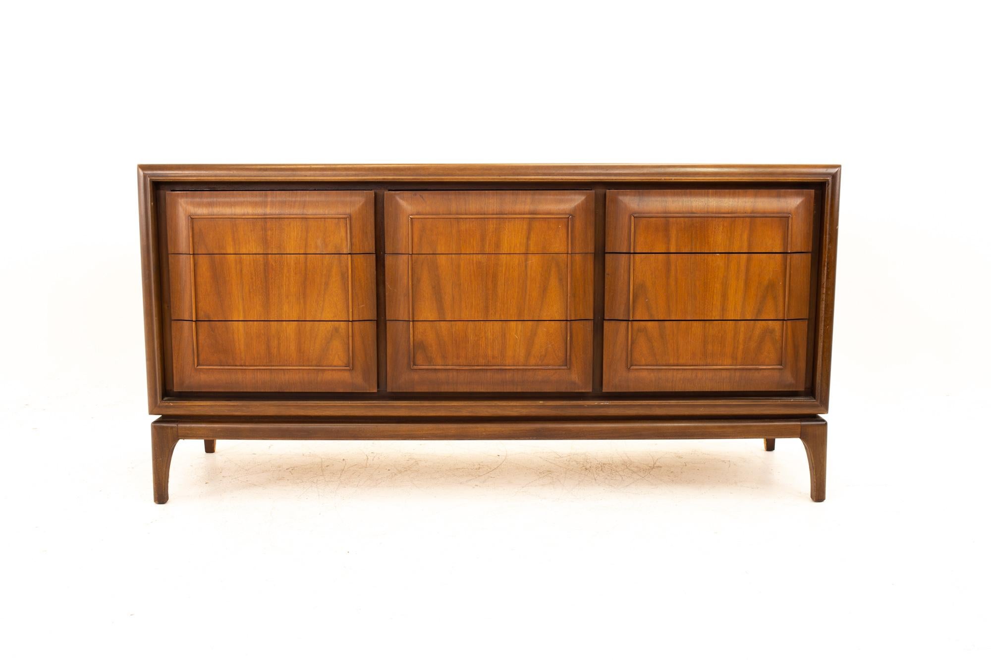 United Furniture Mid Century Walnut 9 Drawer Lowboy Dresser

Dresser measures: 64 wide x 19 deep x 32 inches high

All pieces of furniture can be had in what we call restored vintage condition. That means the piece is restored upon purchase so it’s