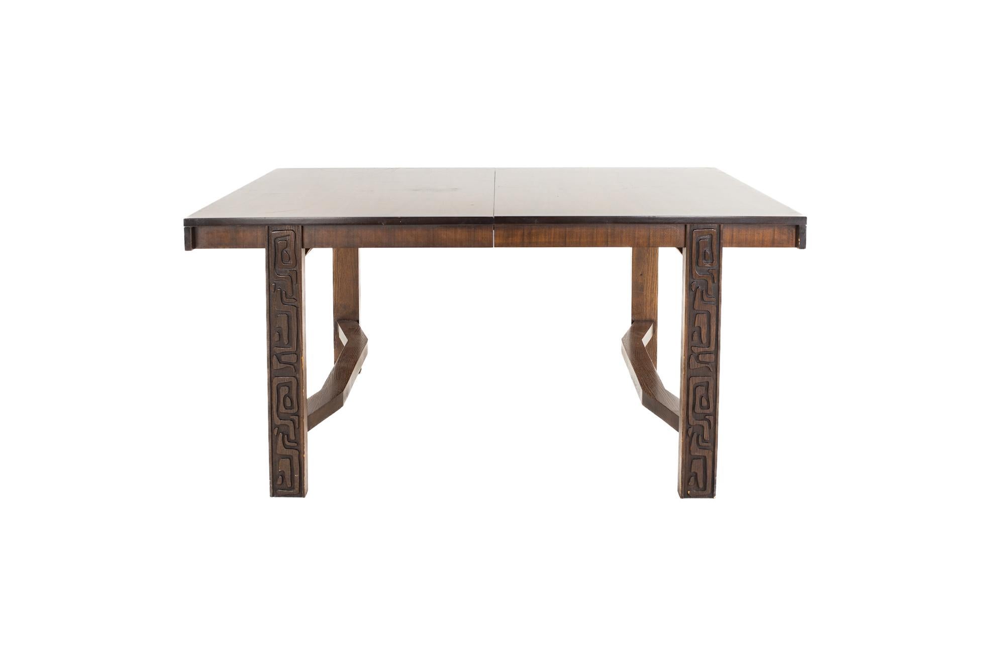 United Furniture mid century walnut Tiki Brutalist dining table

The table measures: 62 wide x 42 deep x 30 high, with a chair clearance of 26.25 inches; each leaf is 18 inches wide, making a maximum table width of 98 inches when both leaves are
