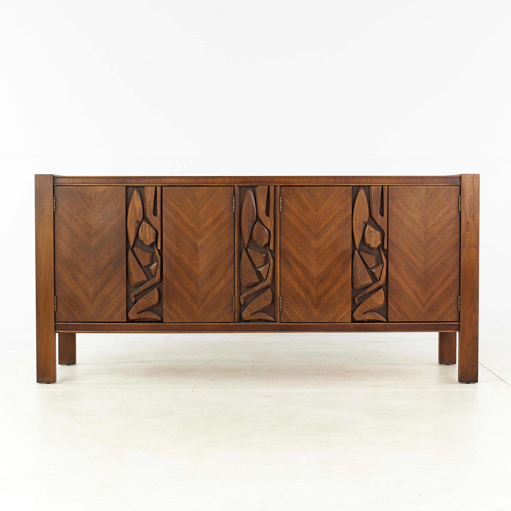 United Mid Century Tiki Brutalist walnut sideboard buffet credenza

This credenza measures: 69 wide x 20 deep x 32.5 inches high

All pieces of furniture can be had in what we call restored vintage condition. That means the piece is restored