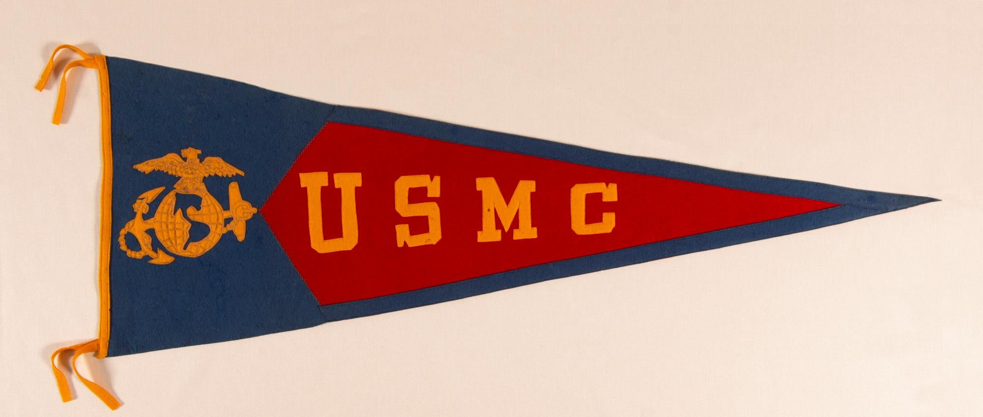 UNITED STATES MARINE CORPS PENNANT OF NOTABLE WEIGHT, QUALITY, & SCALE, circa 1914-1920’s

Large, felt, Marine Corps pennant with appliquéd felt letters and the central device of its official seal, the latter adorned with chain-stitched detailing.