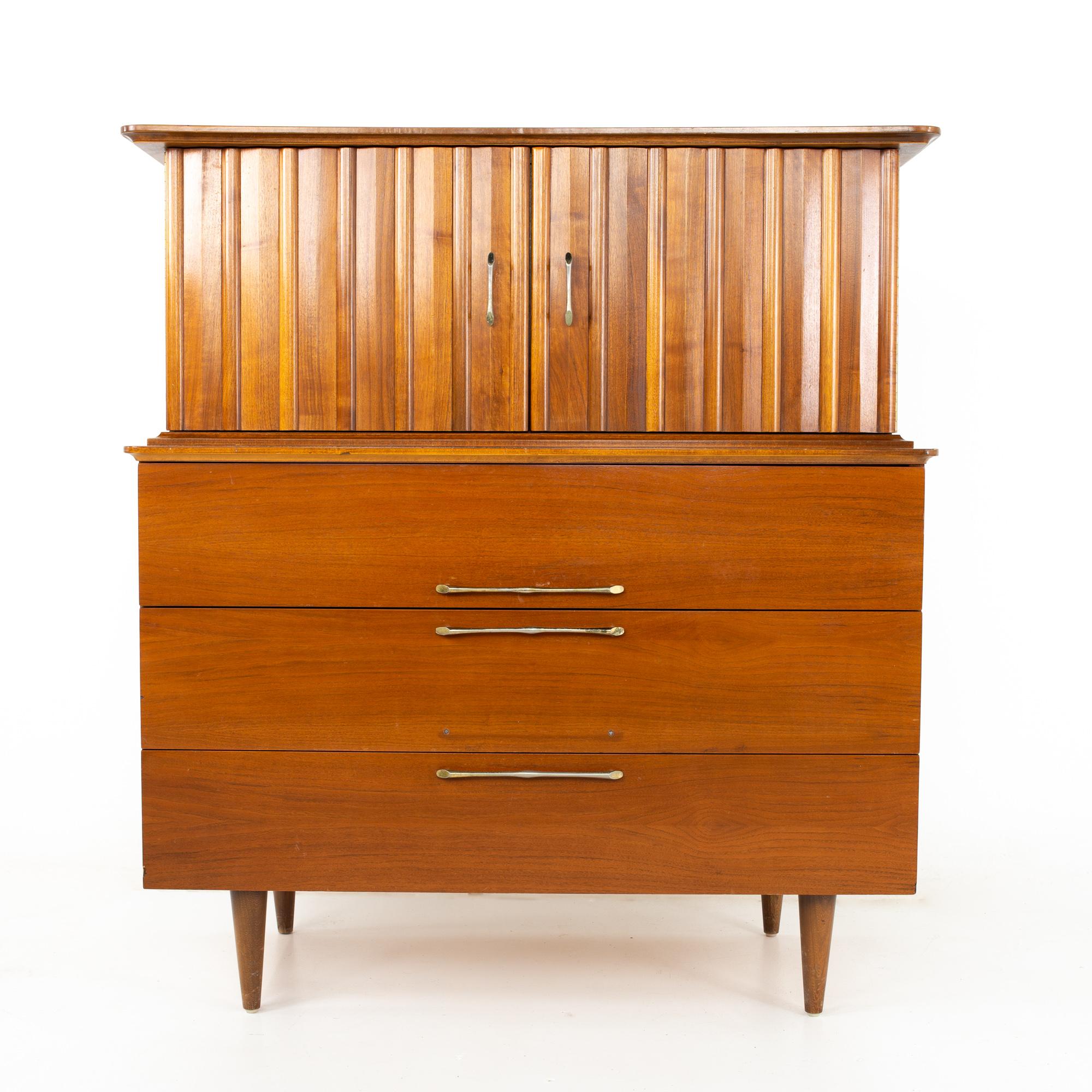 United Style Young Manufacturing mid century walnut and brass gentleman's chest highboy dresser.

Dresser measures: 42 wide x 19 deep x 46.75 inches high.

All pieces of furniture can be had in what we call restored vintage condition. That means