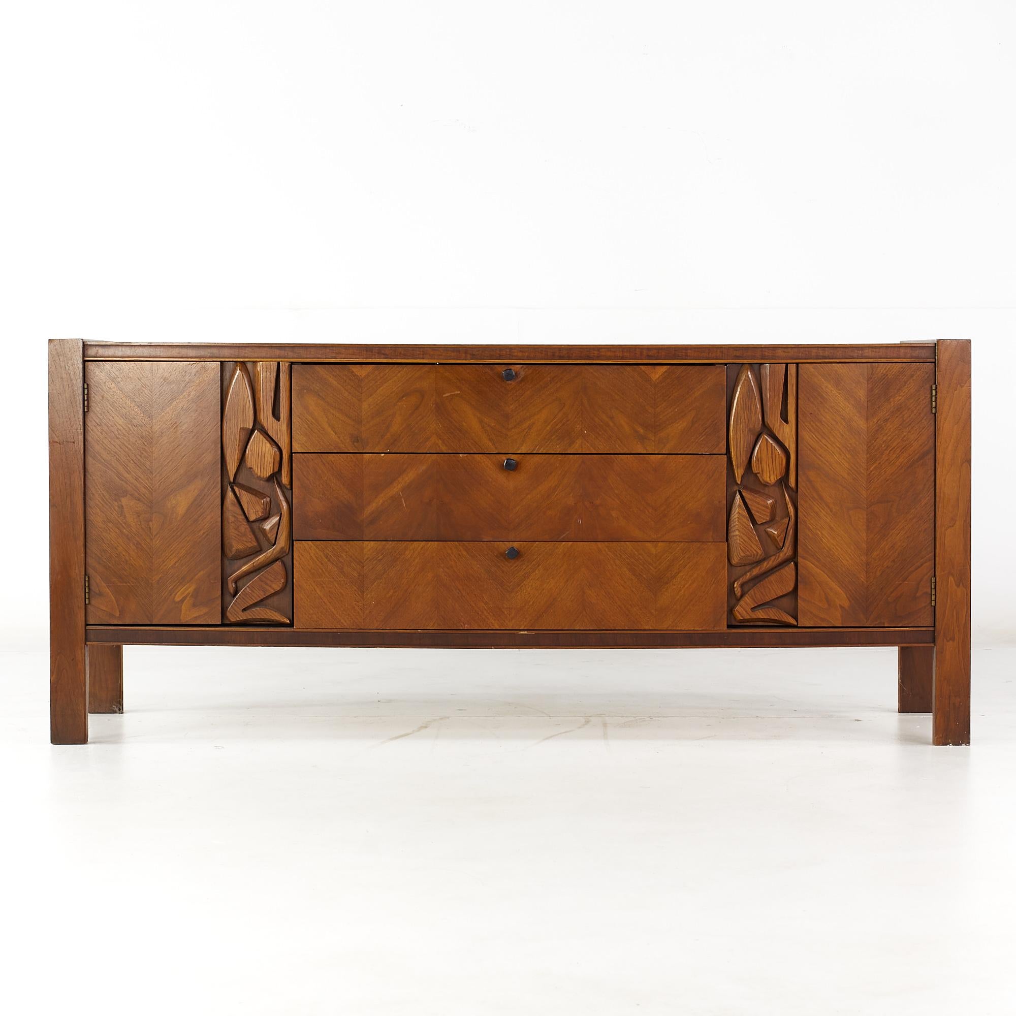 United Tiki Brutalist Mid Century walnut 9 drawer lowboy dresser

This lowboy measures: 74 wide x 20.25 deep x 30.75 inches high

All pieces of furniture can be had in what we call restored vintage condition. That means the piece is restored