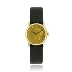 Reloj Universal Geneve de oro amarillo de 14 quilates con esfera de monedas