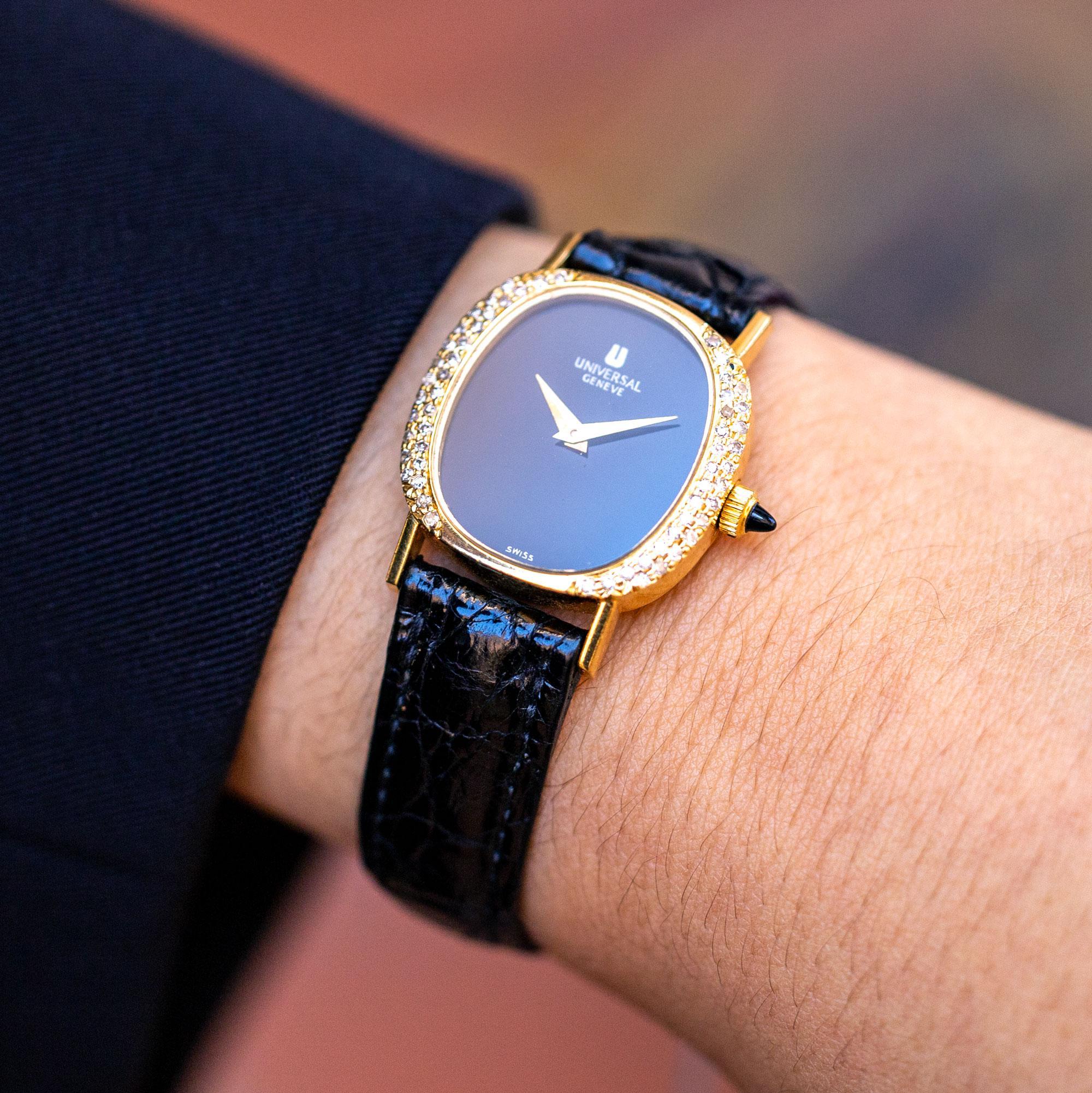 A fantastic vintage 1970s ladies Universal Geneve ladies cocktail watch, reminiscent of the timeless tank design. The sleek black onyx dial with gold hands is encased in a luxurious 18 karat yellow gold case, festooned with 58 sparkling diamonds,