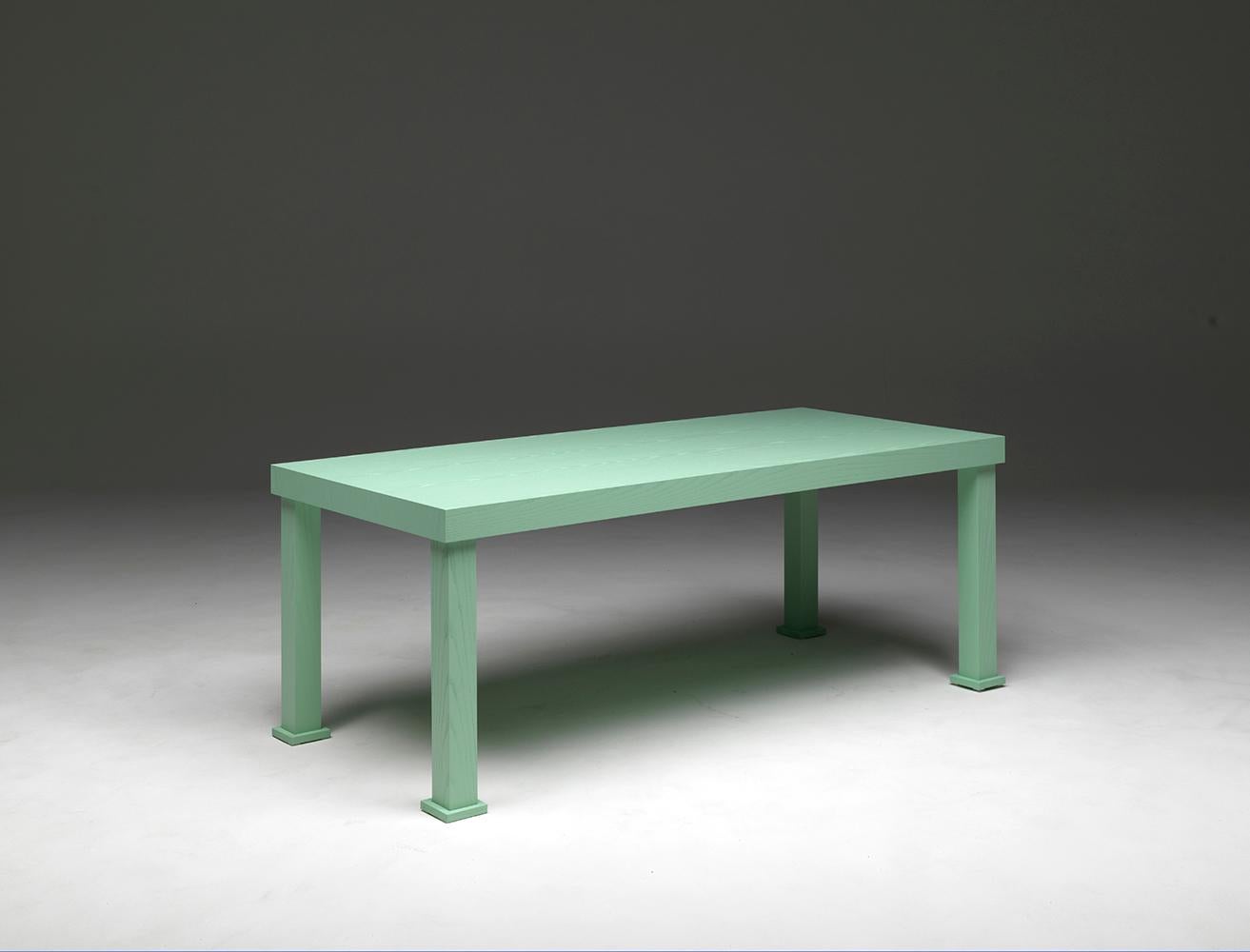 Universal Living, rectangular dining table in open-pore lacquered ash wood, marine green color, with square section legs. Designed by Aldo Cibic.
A table with a strong yet not exaggerated personality, with warm and pleasant functionality,
easy to