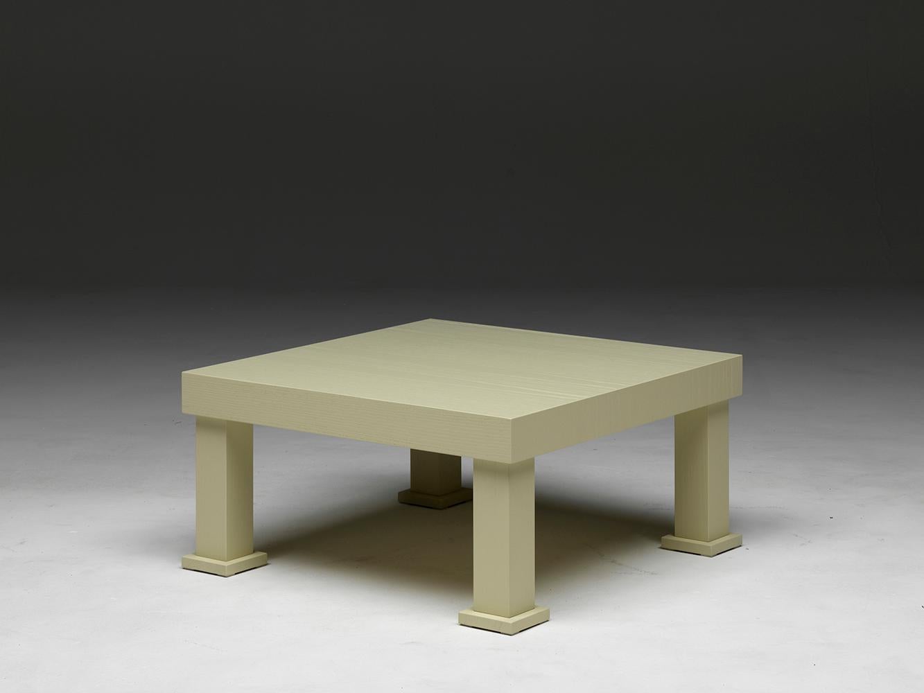 Universal low is a low, squared beige table in open-pore lacquered ashwood, with square section legs. Designed by Aldo Cibic. A low table with a strong yet not exaggerated personality, with warm and pleasant functionality, easy to combine with