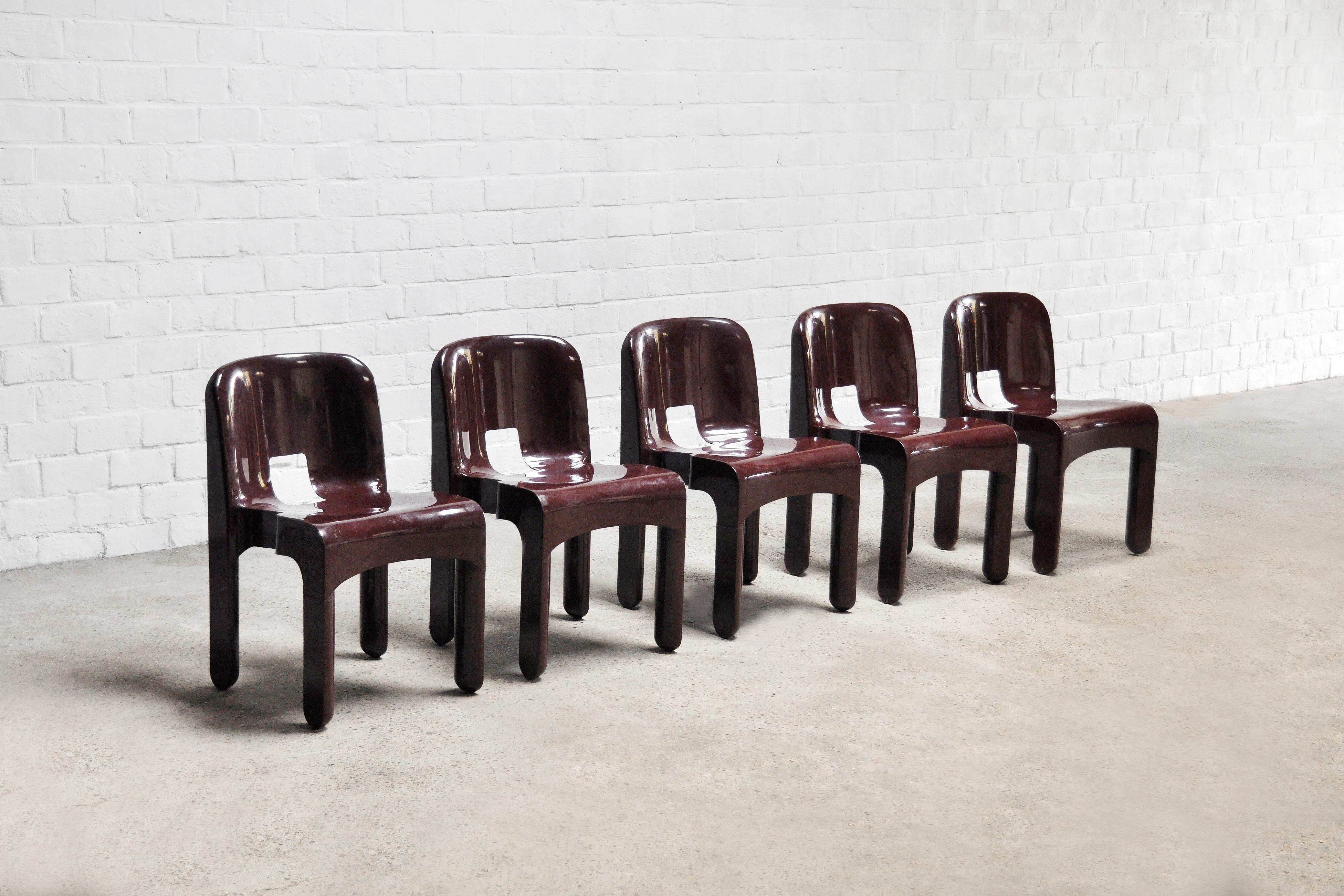 Set of 5 model '4869' chairs designed by Joe Colombo for Kartell in a beautiful maroon color. Original design from the early 70's. These chairs reflect the 60's-70's space-age enthusiasm for modern plastic furniture that was particularly strong in
