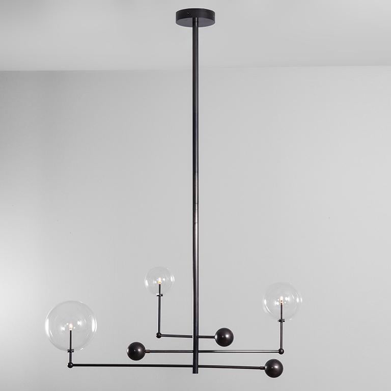 Black gunmetal 3 arm contemporary chandelier by Schwung 
Dimensions: D 25 x W 128.2 x H 178 cm 
Materials: solid brass, hand-blown glass globes
Finish: black gunmetal. 
Also available in finishes: polished nickel or natural brass.
All our lamps