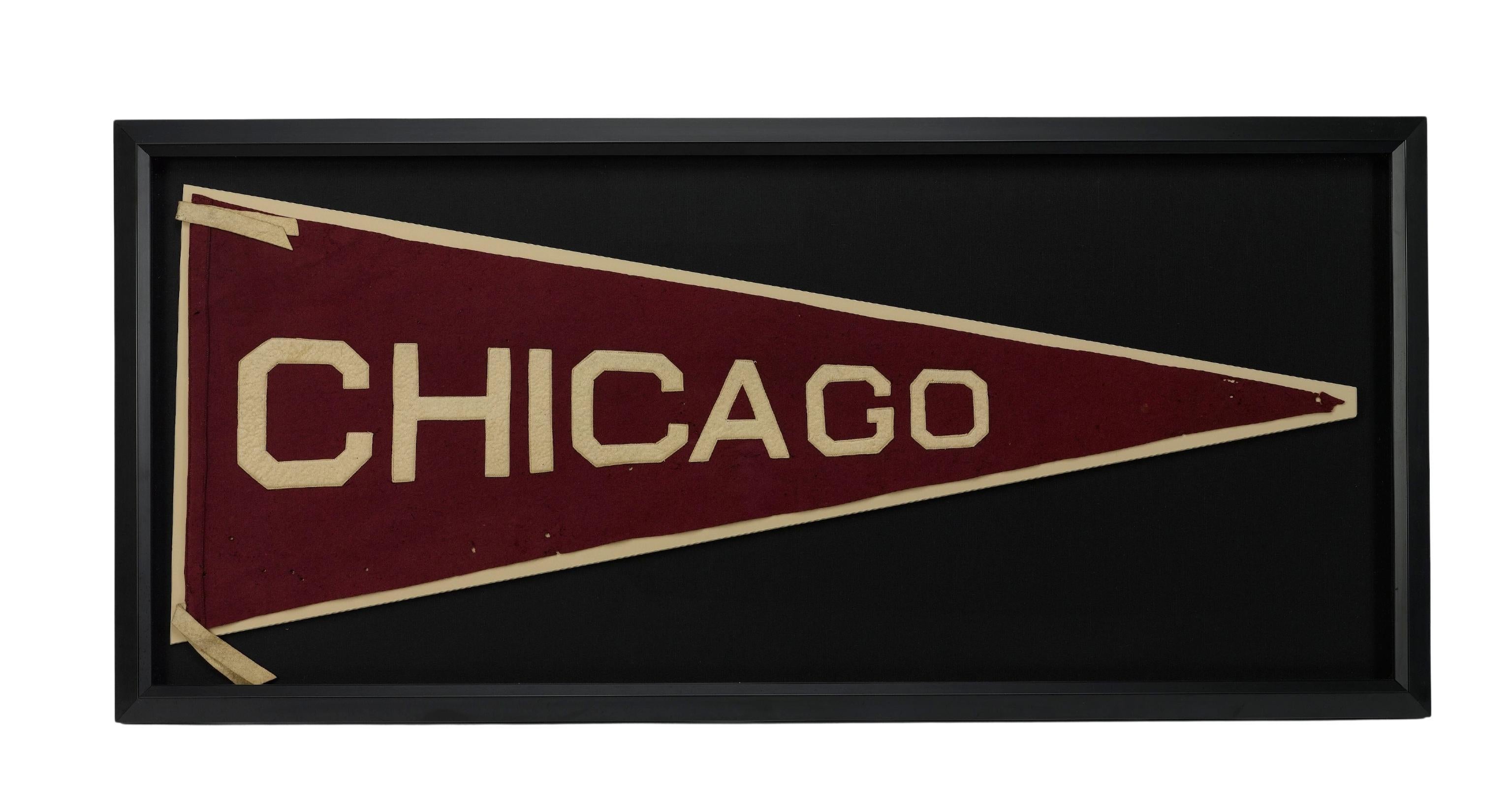 Presented is a vintage University of Chicago felt pennant, dating to 1920-1930. The pennant is burgundy felt, with yellow block letters that read 