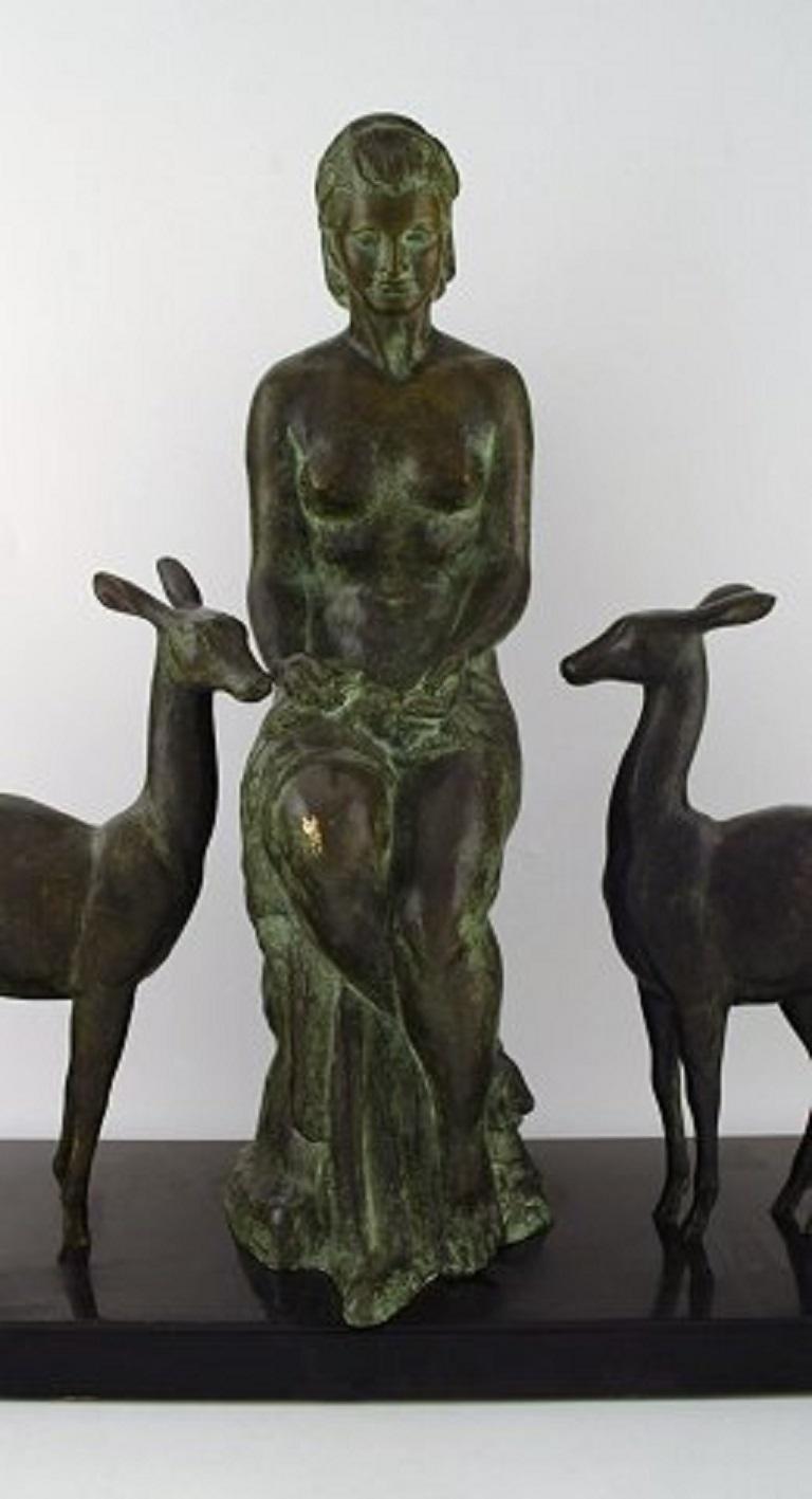 Unknown artist. Large French / Belgian Art Deco sculpture in solid bronze on black marble Stand. Naked woman with two baby deer. 1930s-1940s.
Measures: 60 x 50 cm.
In very good condition.