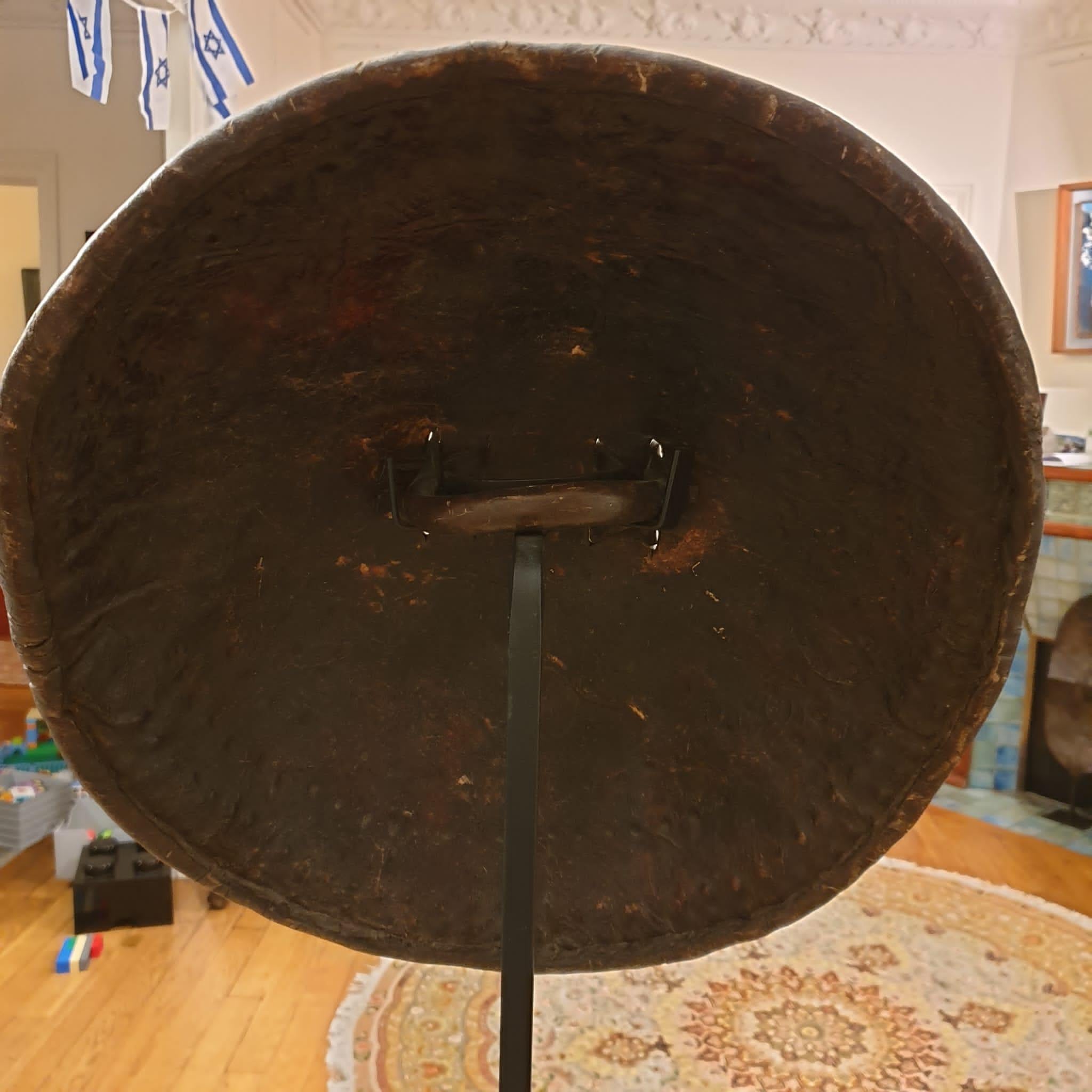 The Amhara Shield is an artful creation crafted around 1910 in the Lake Tana region of northern Ethiopia. Made from buffalo or hippopotamus leather, it features a sturdy steel base. With a diameter of 70 cm, it stands as an impressive and culturally
