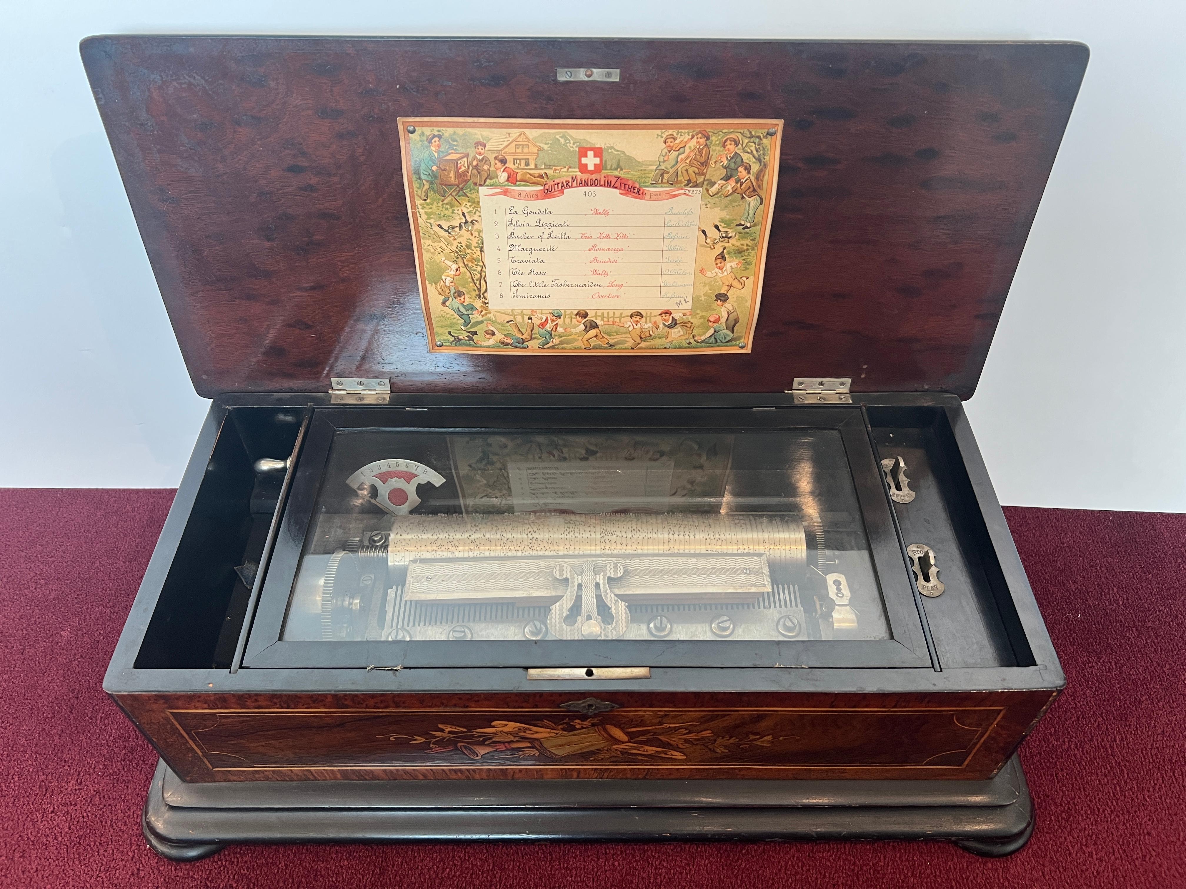 *PLEASE INQUIRE IF YOU HAVE QUESTIONS AND/OR IF YOU WOULD LIKE US TO SEND A VIDEO WITH THE MUSIC PLAYING.

Beautiful Antique Swiss Music Box, Inlaid with Guitar, Mandolin, and Zither
In Working Condition
Late 19th Century
Plays 8 Tunes
11