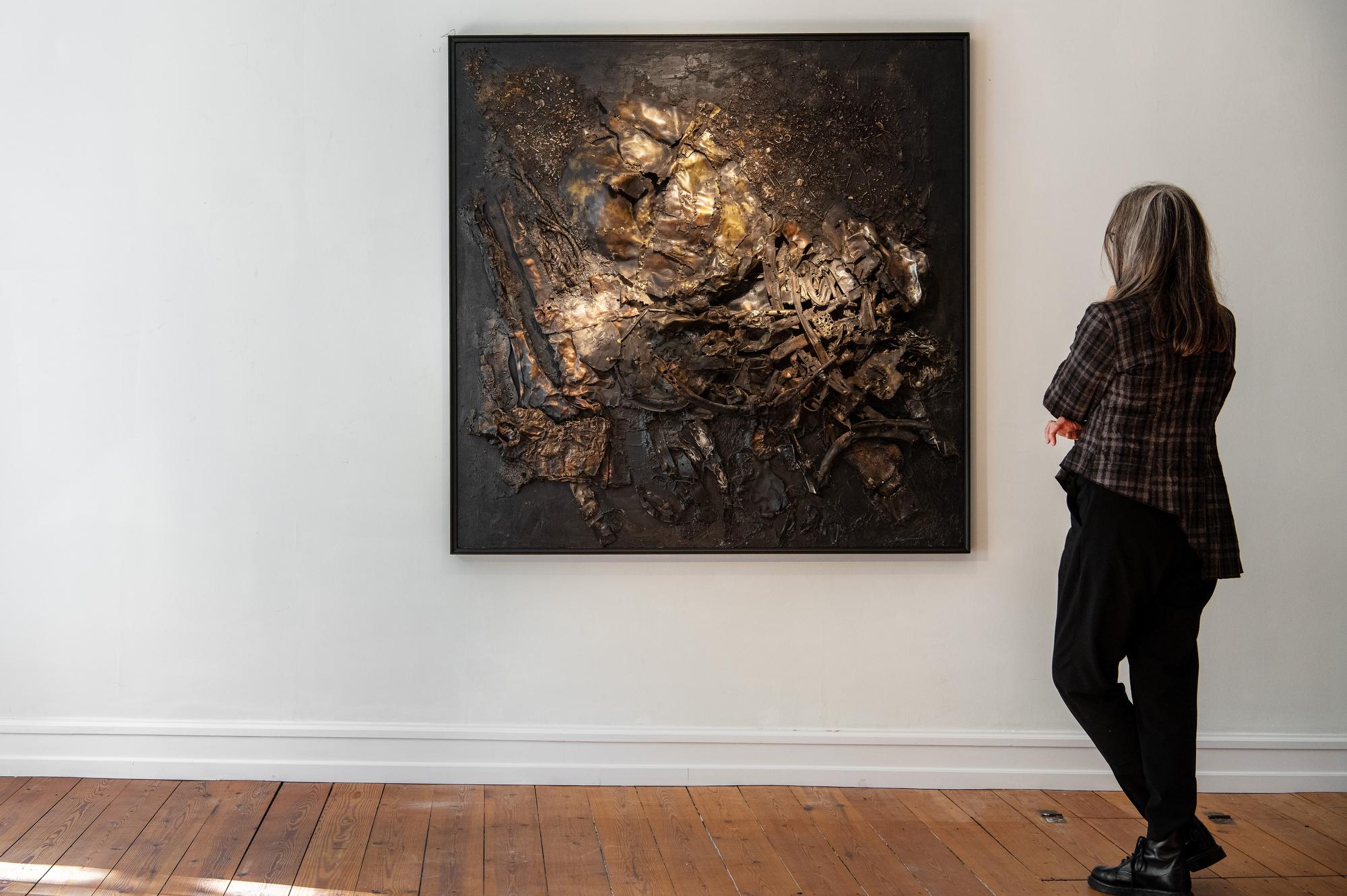 Presenting an extraordinary and commanding work of art, an extra-large metal assemblage in post-war style which truly makes a statement. The patinated metal objects create a rich, darkened and golden metallic nuances that are deep and saturated. The