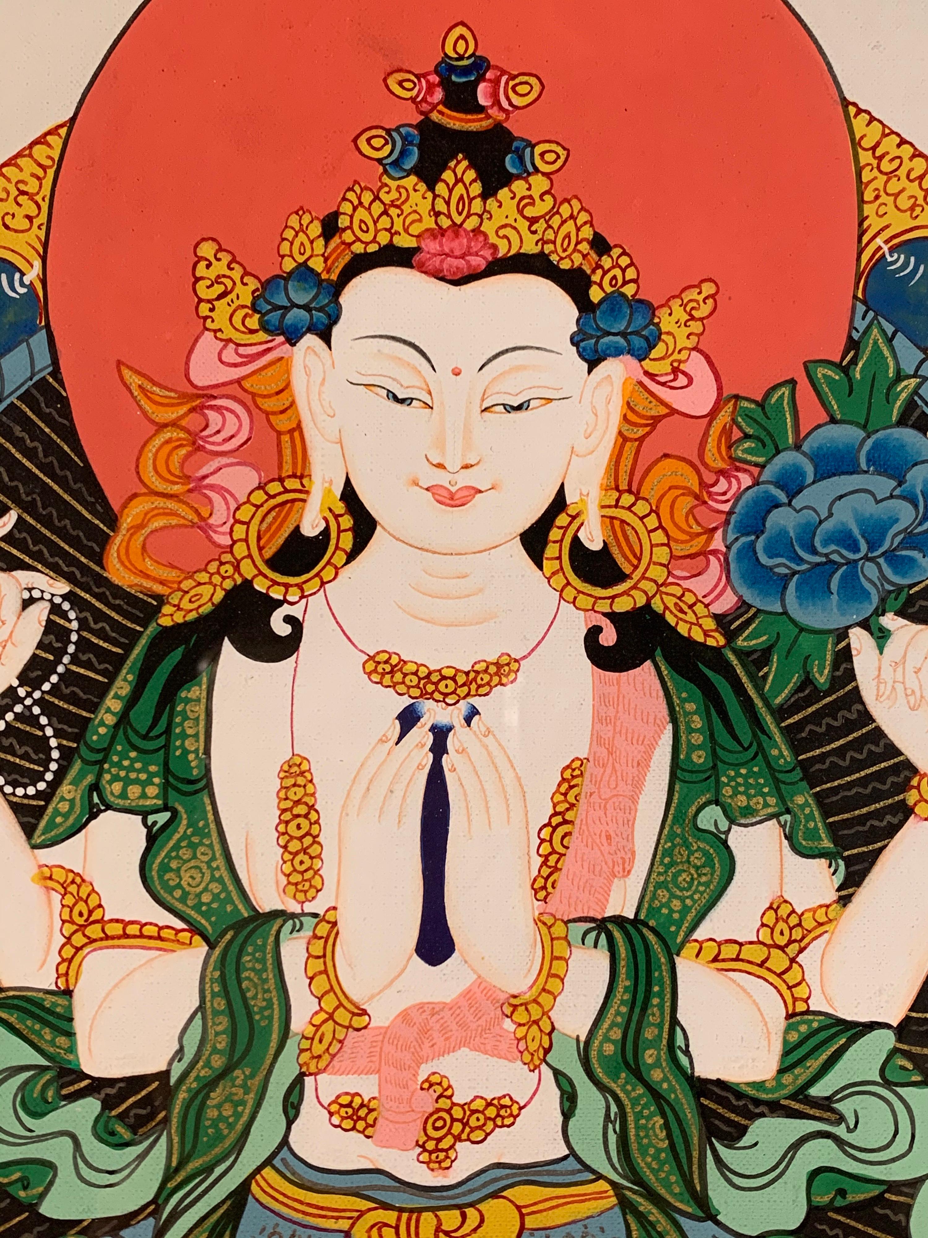 This figurative hand-painted thangka is of Chen-re-zig also known as the Buddha of Compassion. 
It is believed that Chenrezig is the embodiment of boundless loving-kindness and compassion. Every person whose heart is moved by love and compassion,