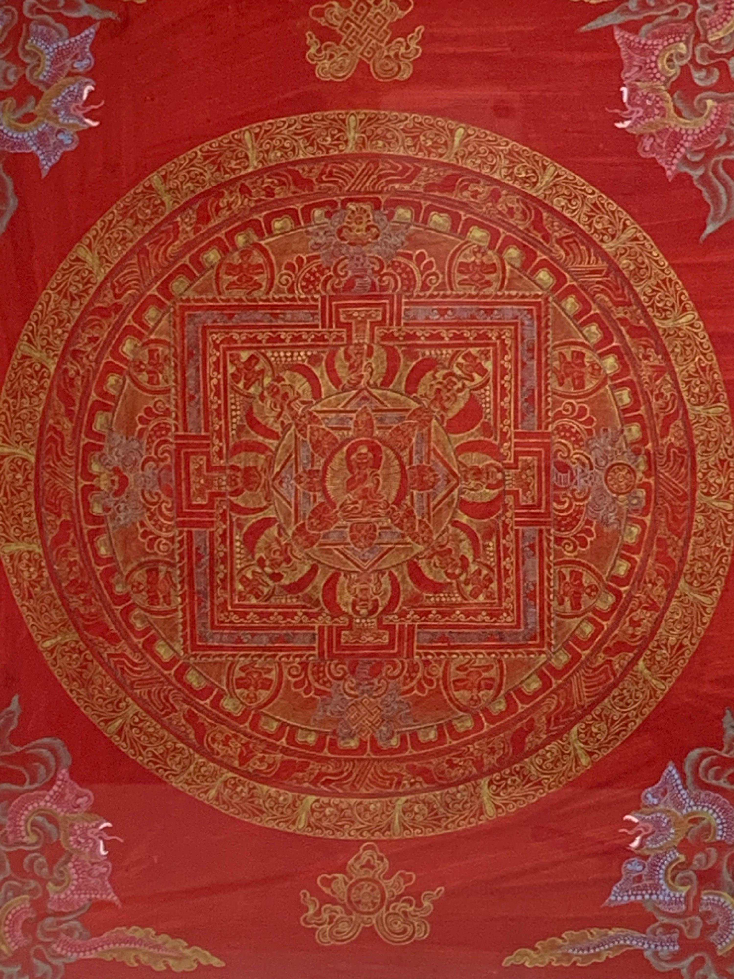 This mandala thangka is hand painted on canvas with 24k gold. Shimmering gold on red background makes it a unique piece of art. Unframed size of canvas measures 12